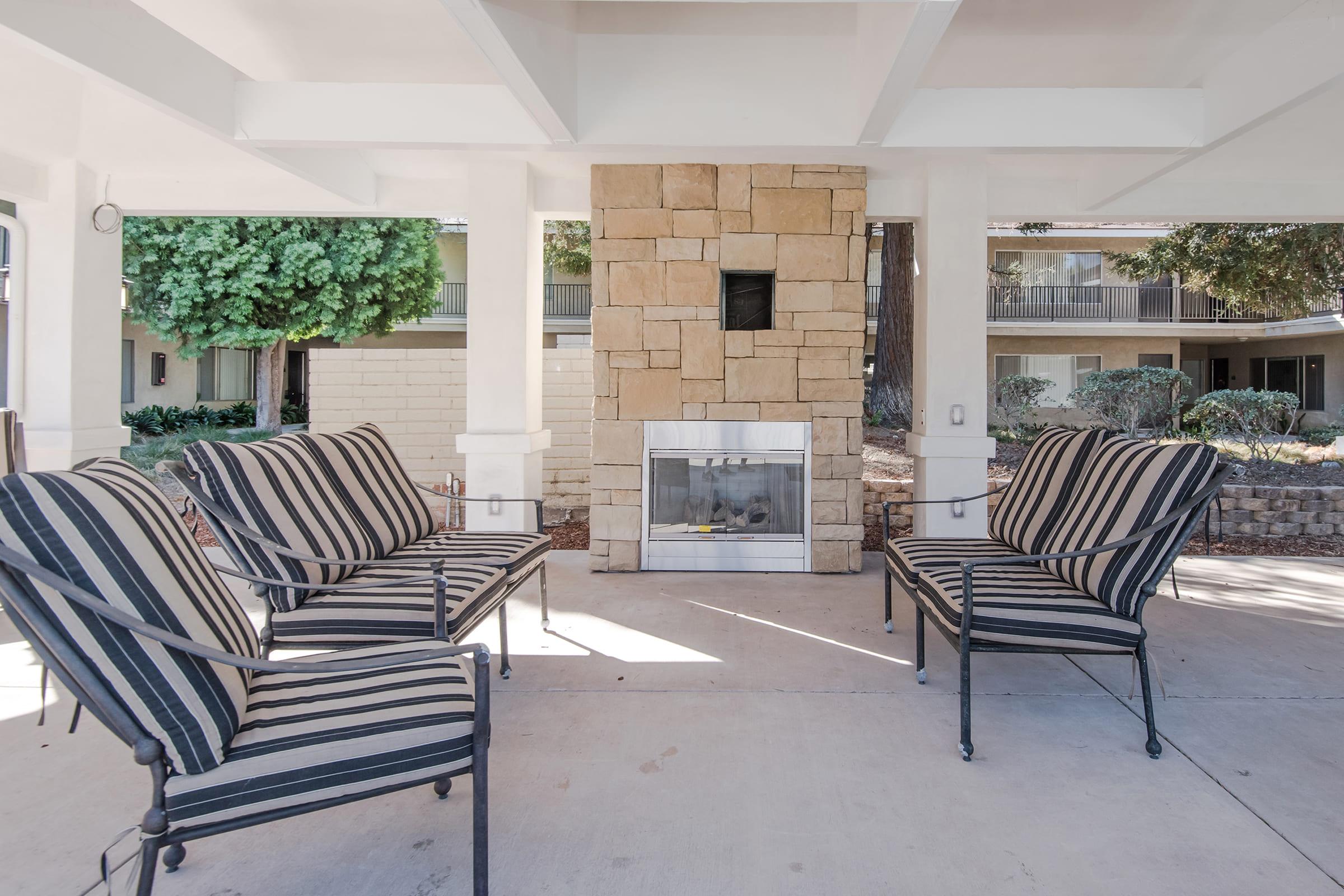 an outdoor fireplace with seating