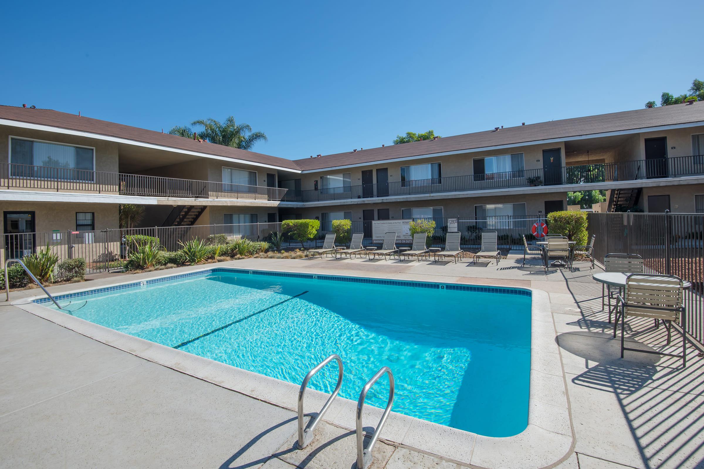 a pool with lounge chairs