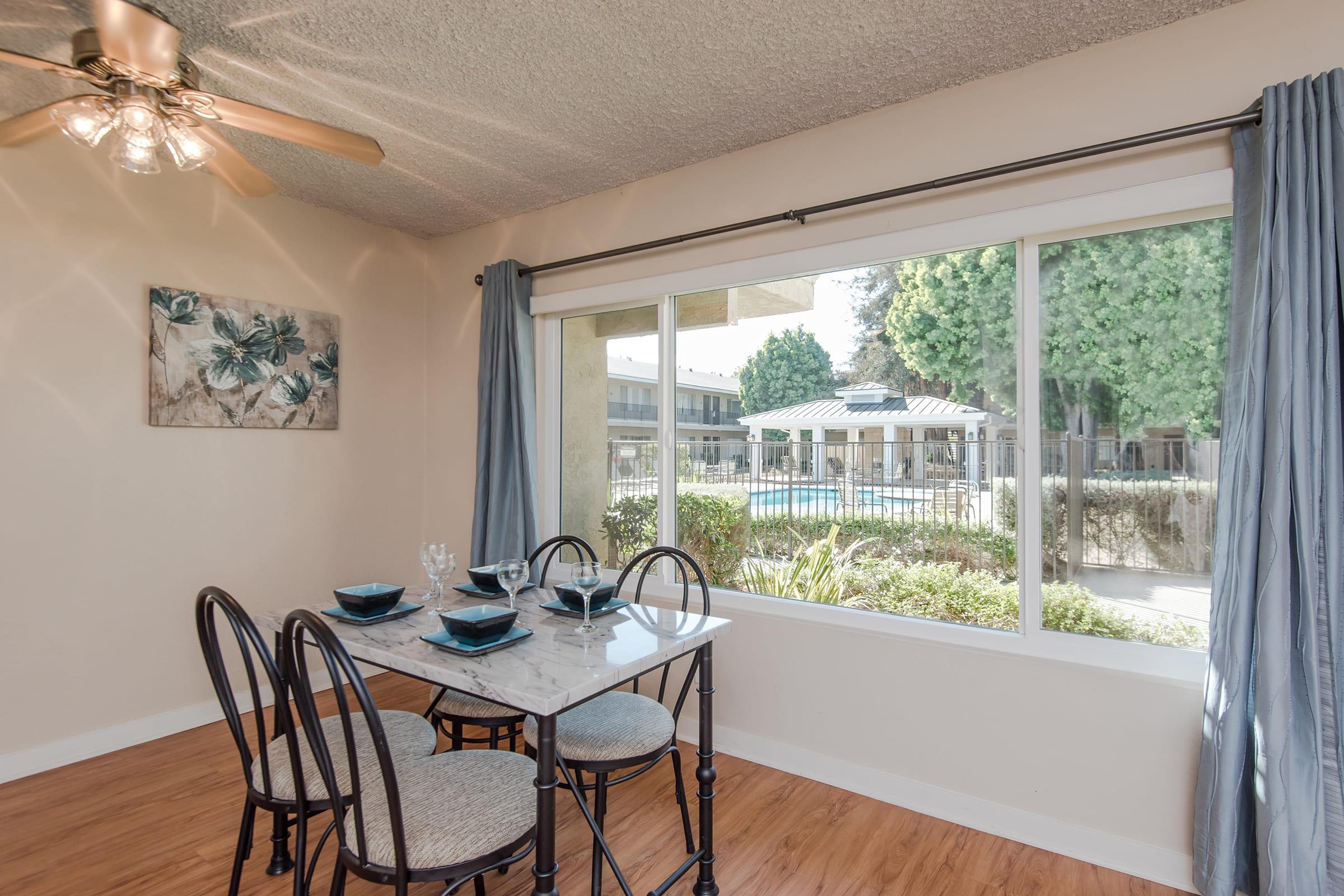 a dining room table in front of a window