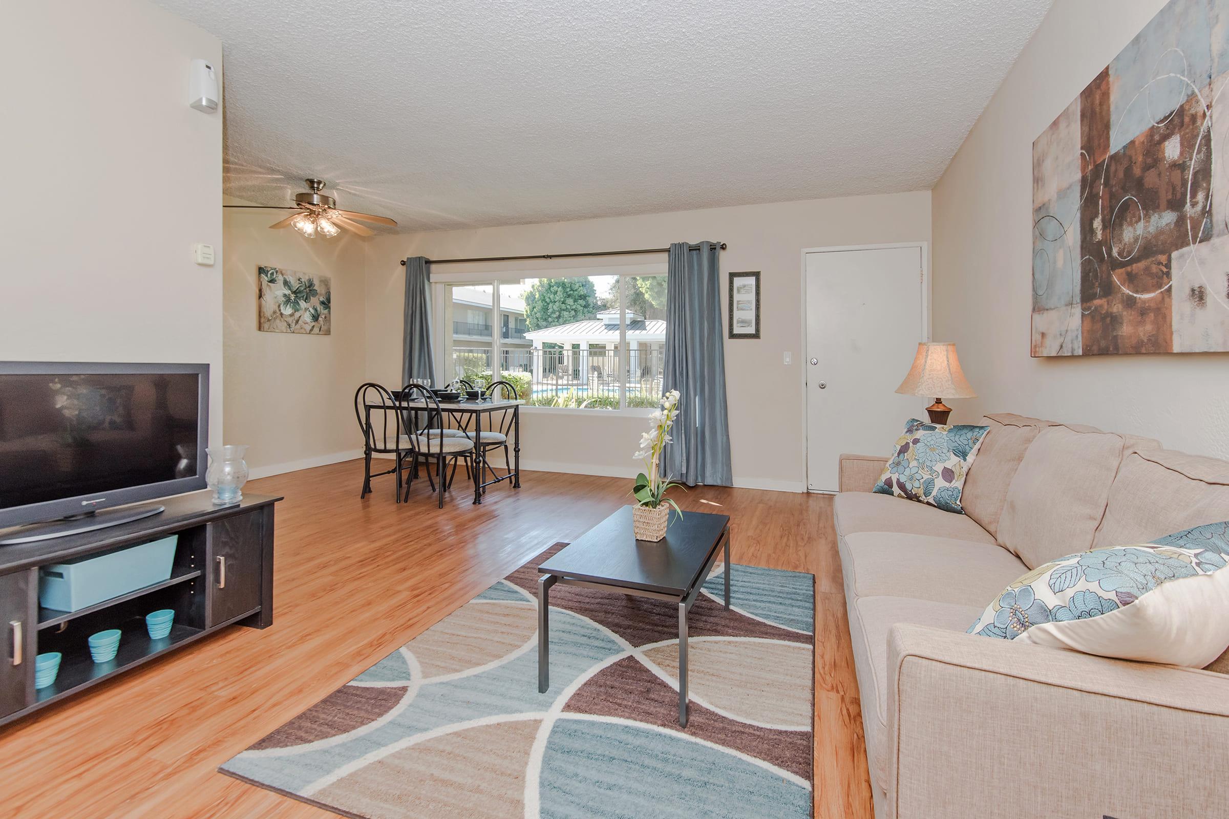 a living room filled with furniture and a tv