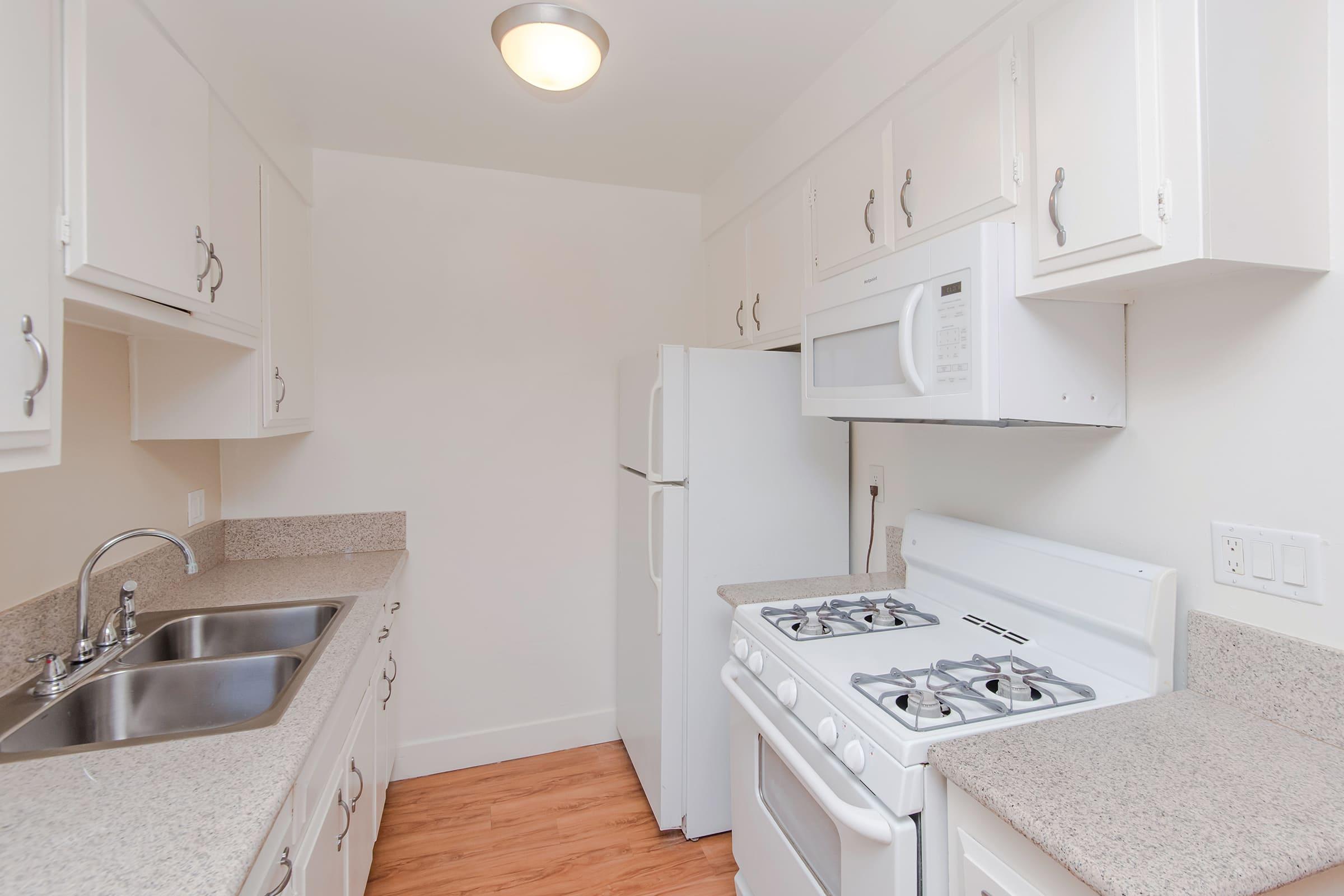 a kitchen with white cabinets