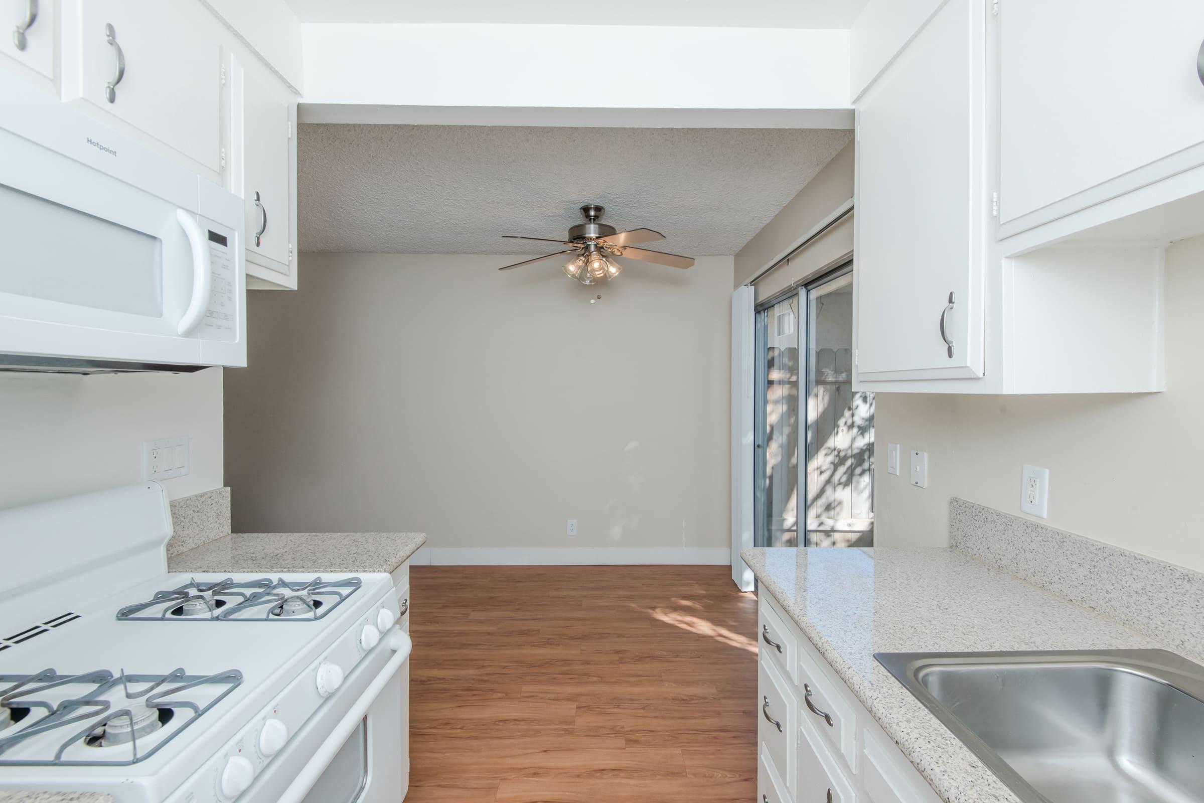 a kitchen with a stove a sink and a microwave