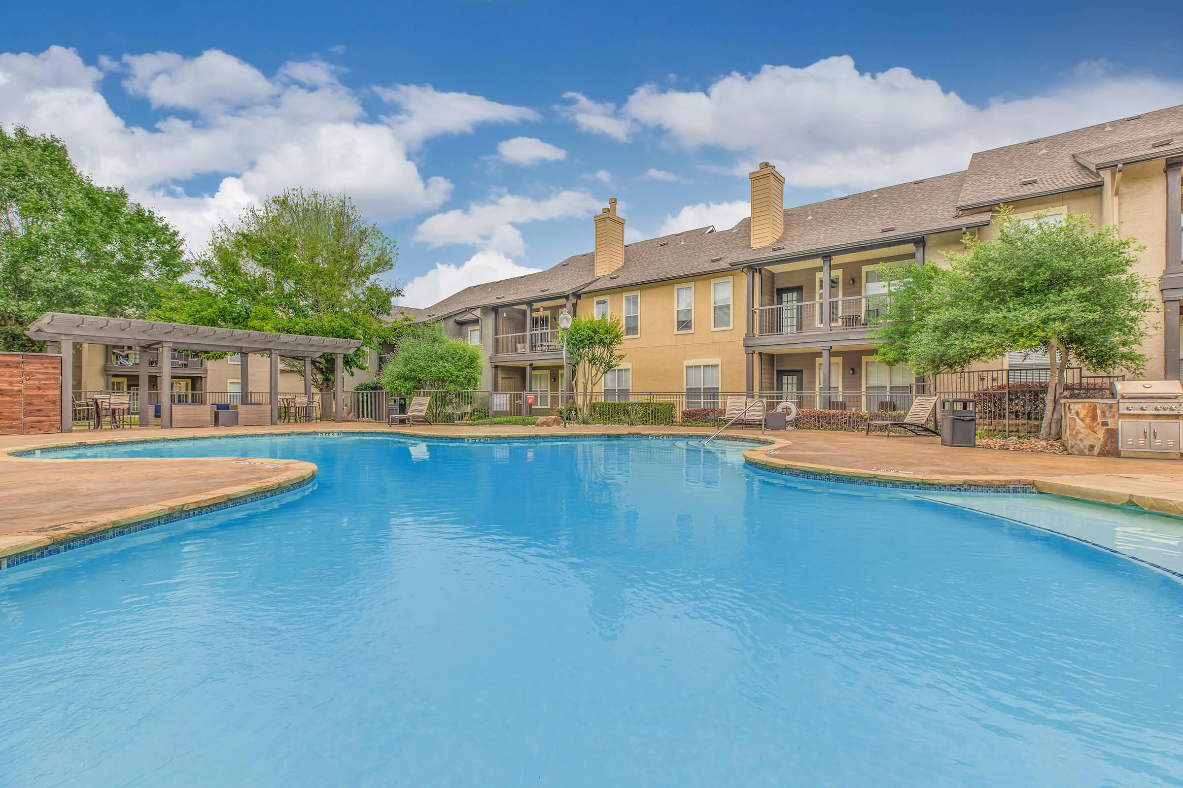 The Ranch at Ridgeview Apartments community pool with a pergola