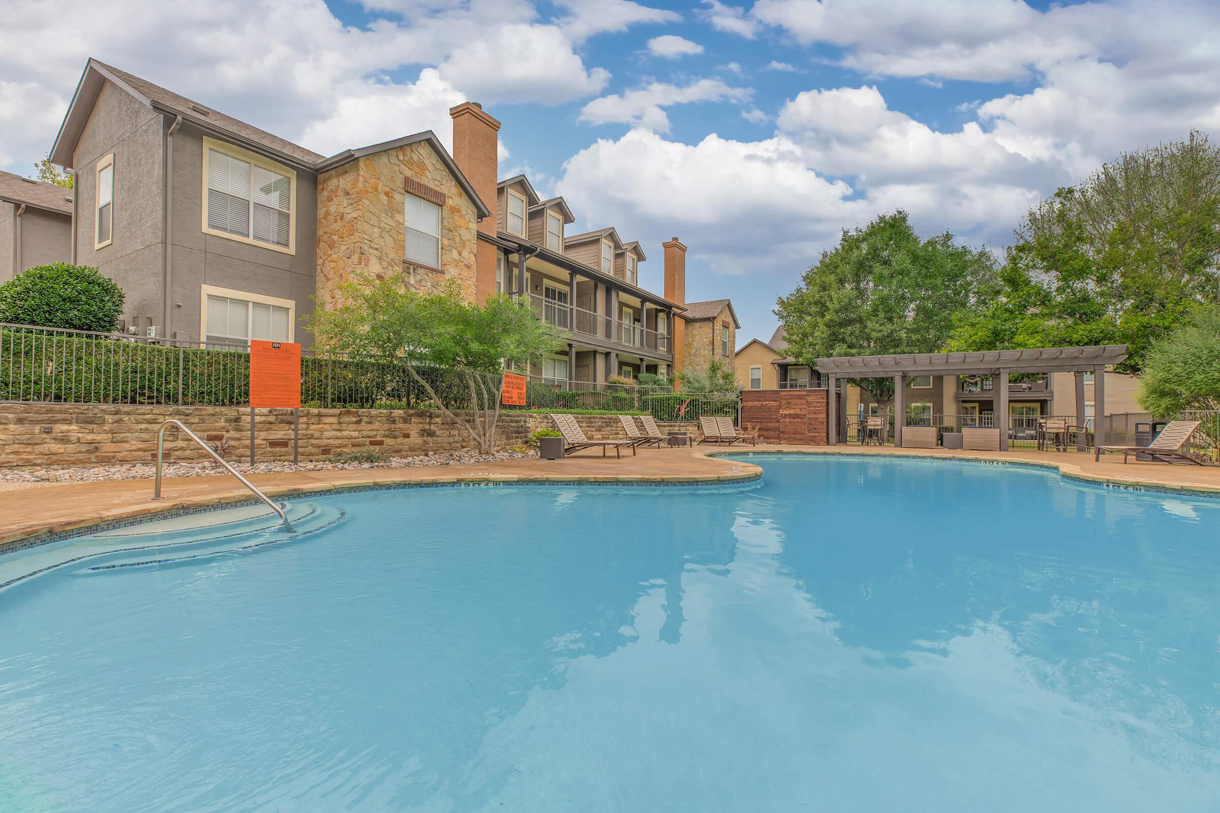 a community pool with a pergola