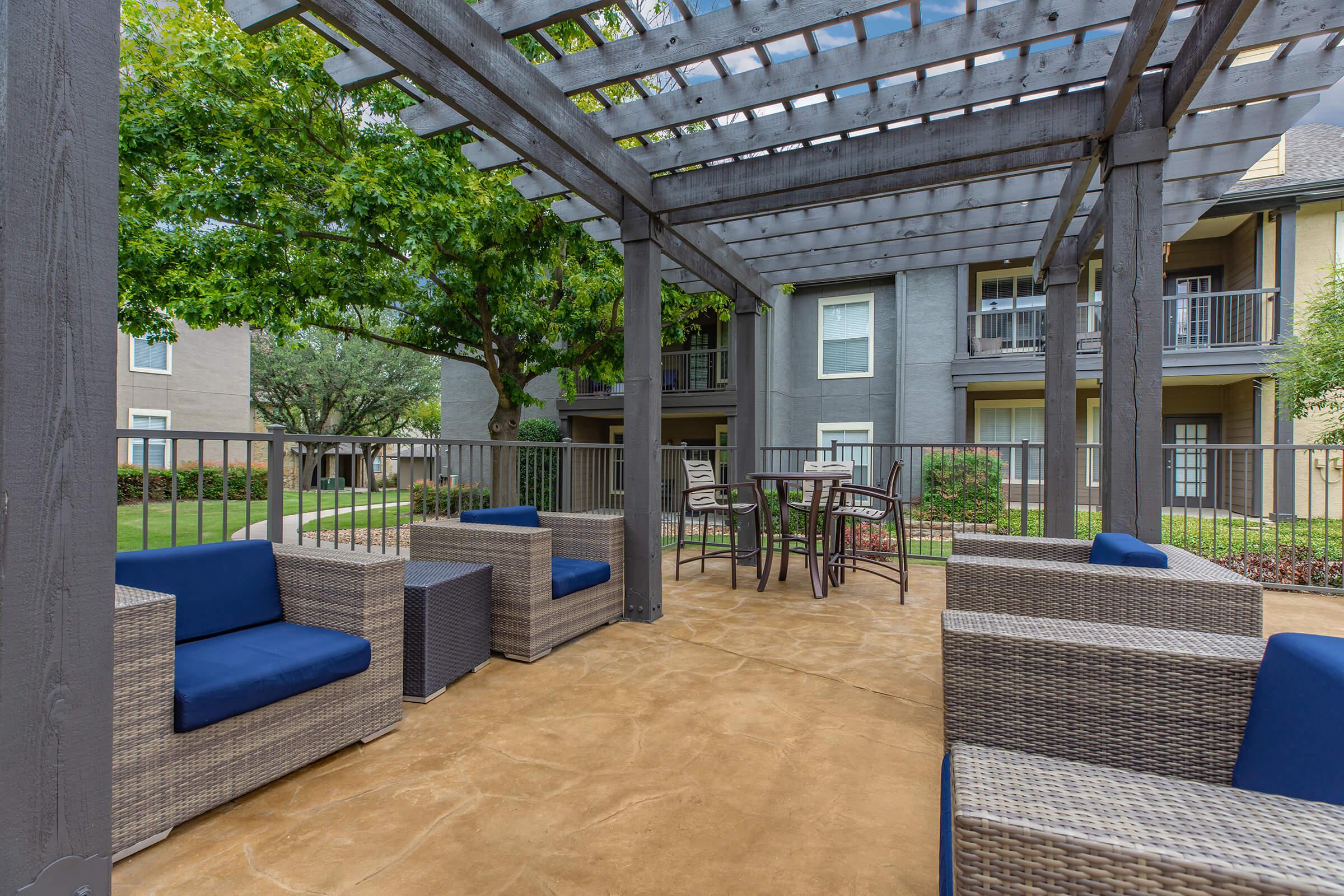 wicker chairs under a pergola