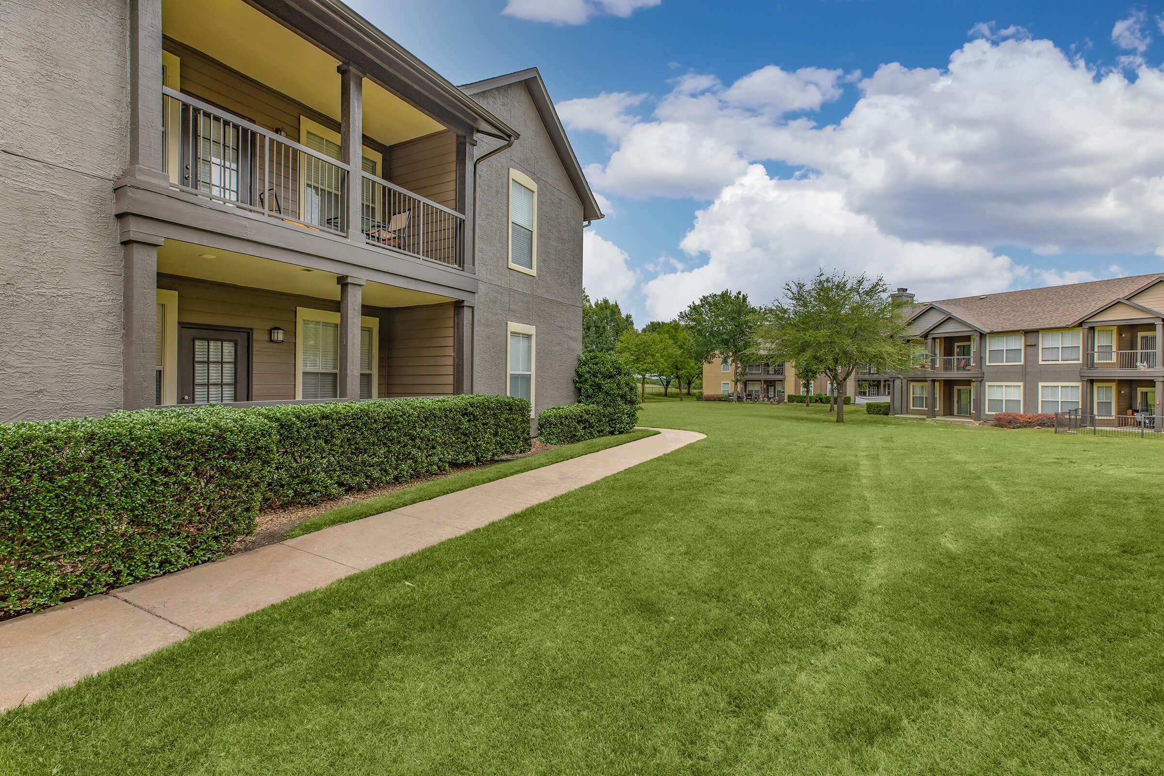 The Ranch at Ridgeview Apartments community buildings with green shrubs