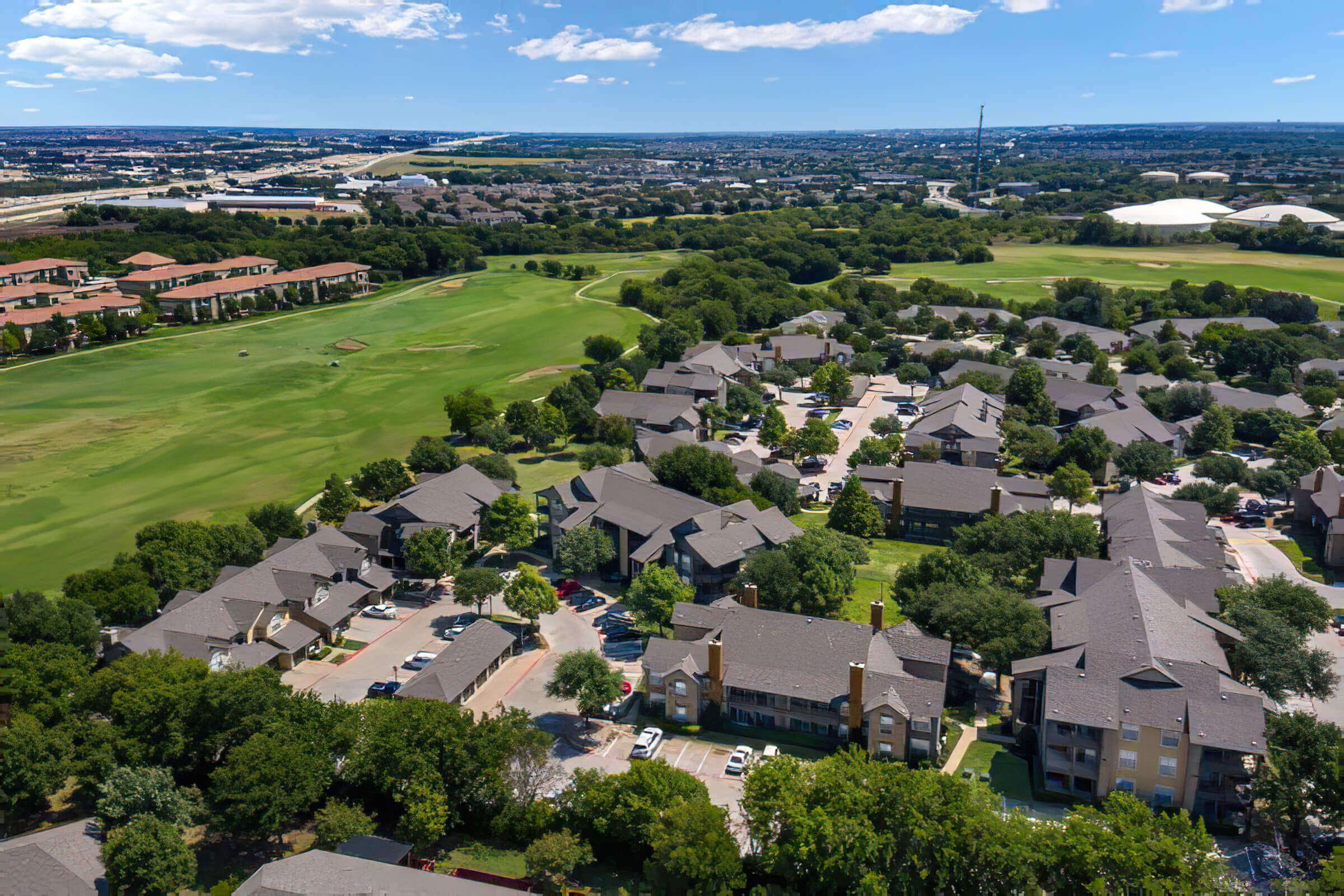 community buildings surrounded by green trees