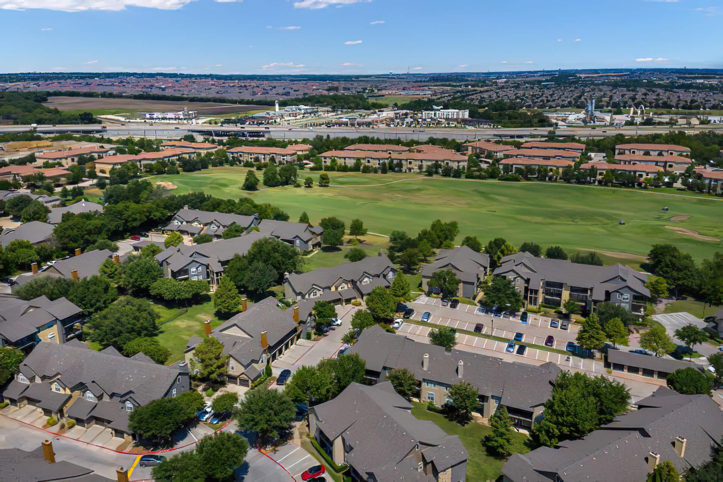 community buildings next to a green field