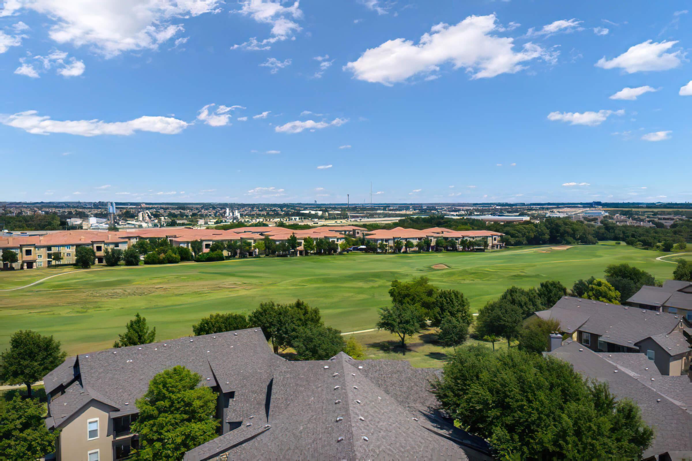 the community buildings next to a green field