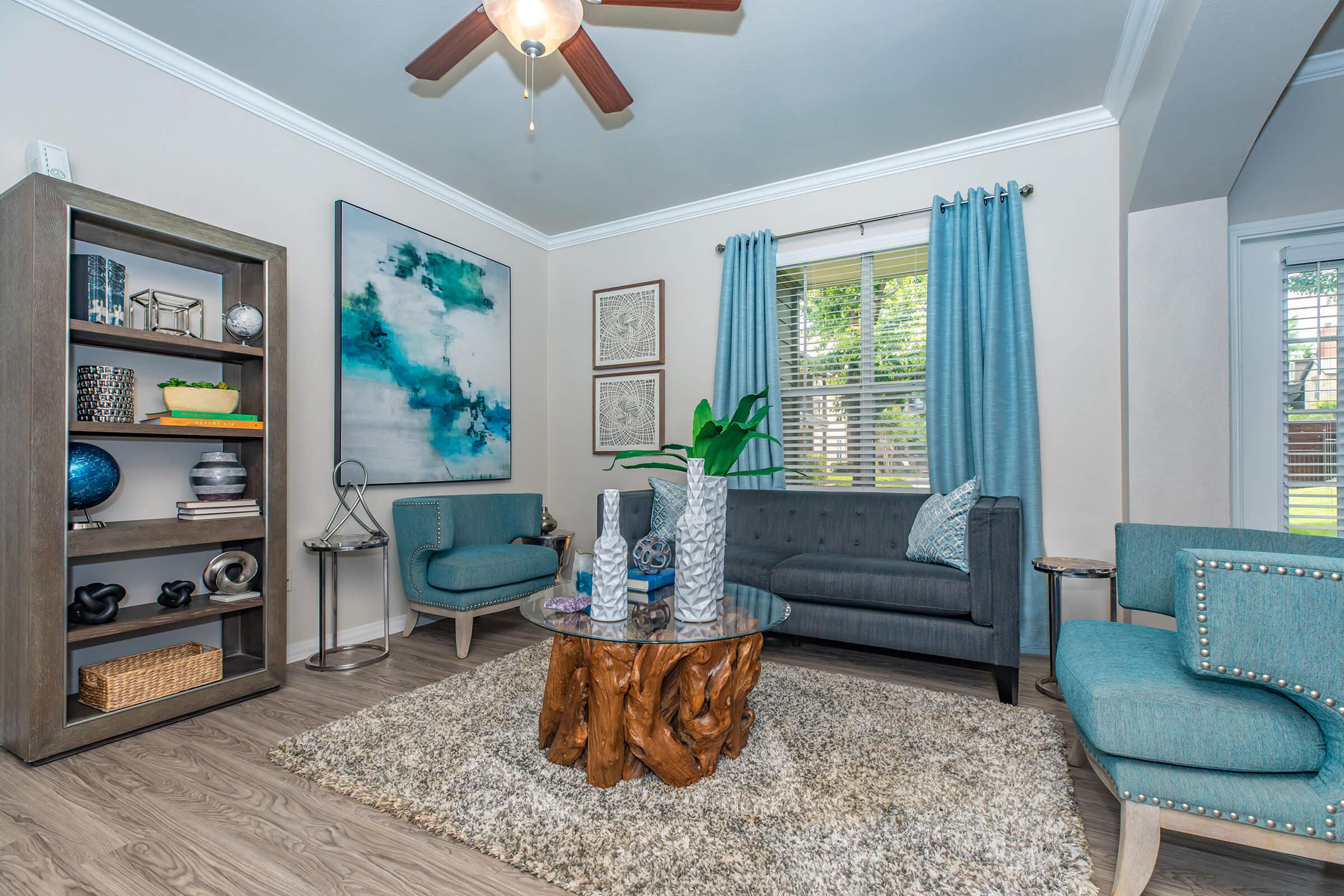 a living room with blue couches