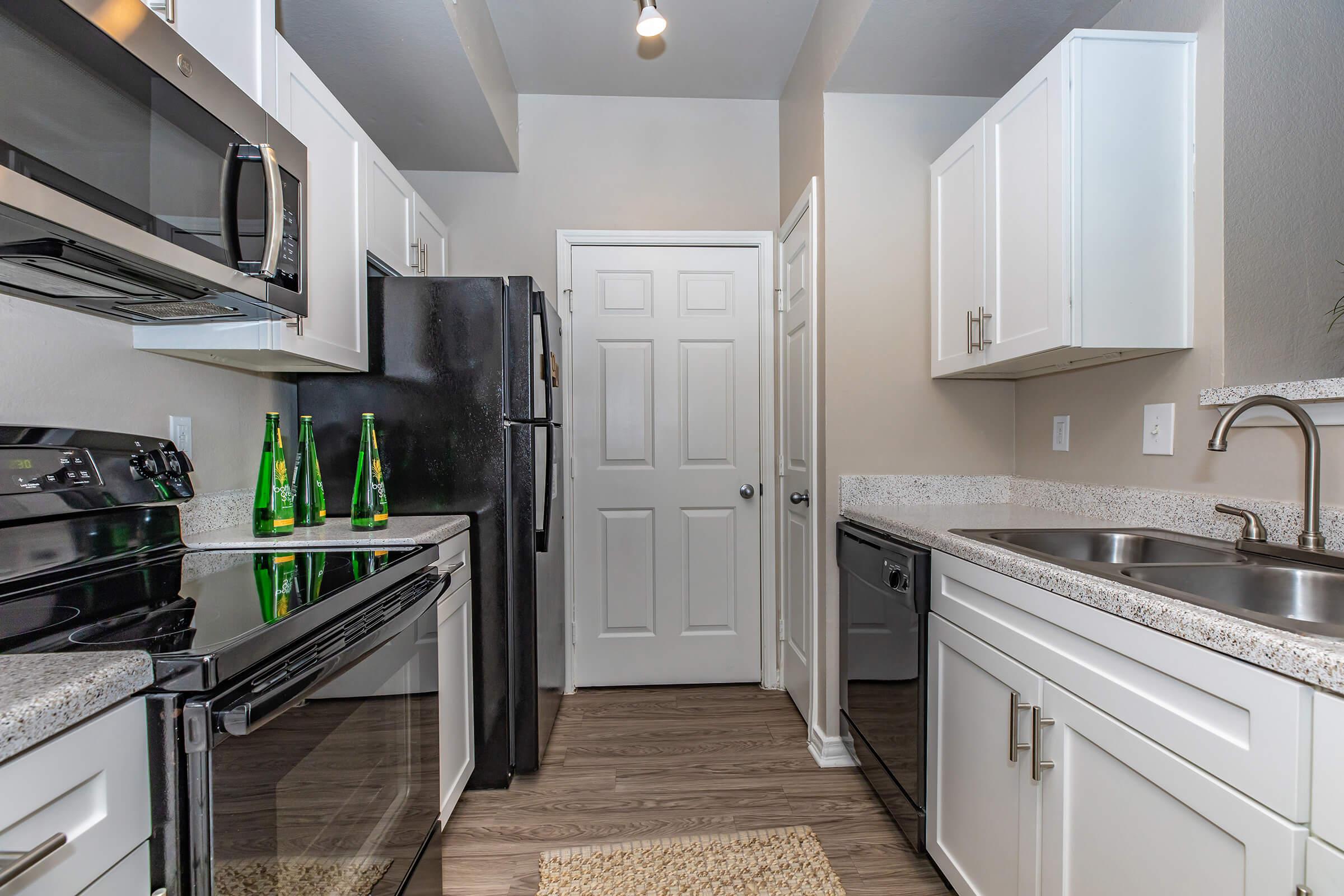 a kitchen with white cabinets