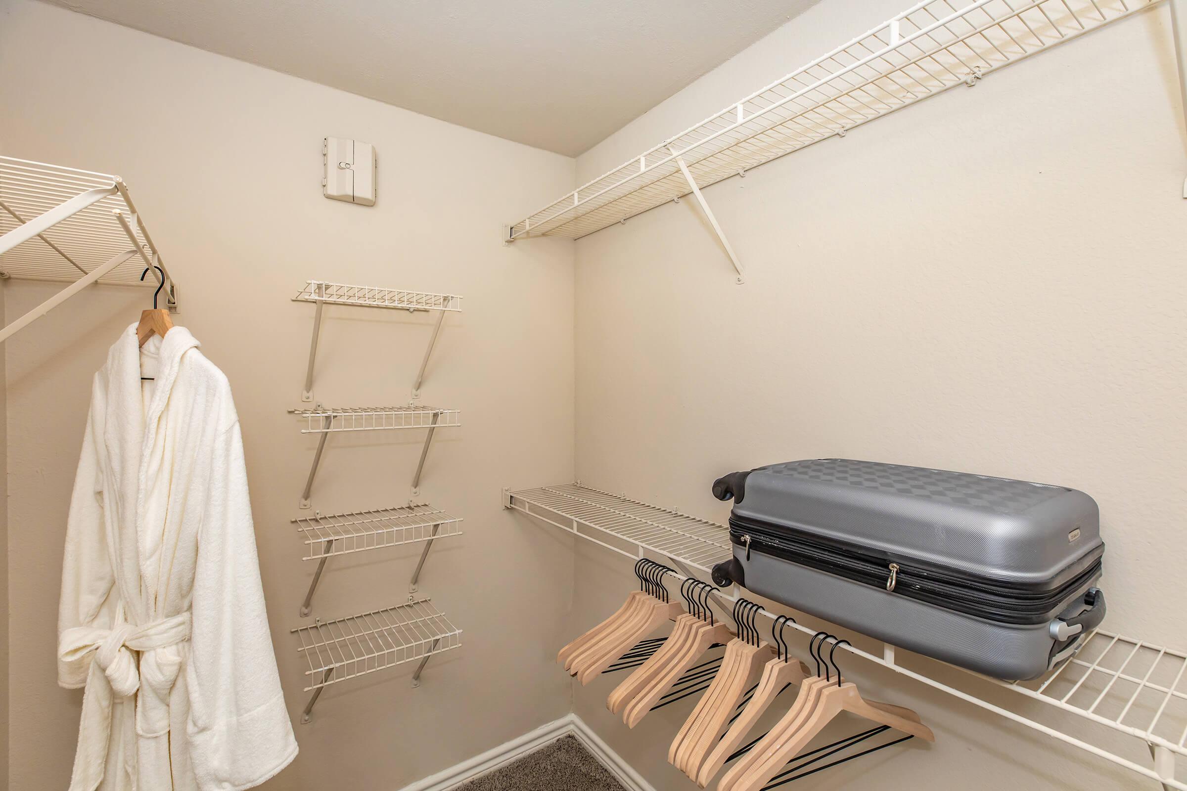 a walk-in closet with luggage