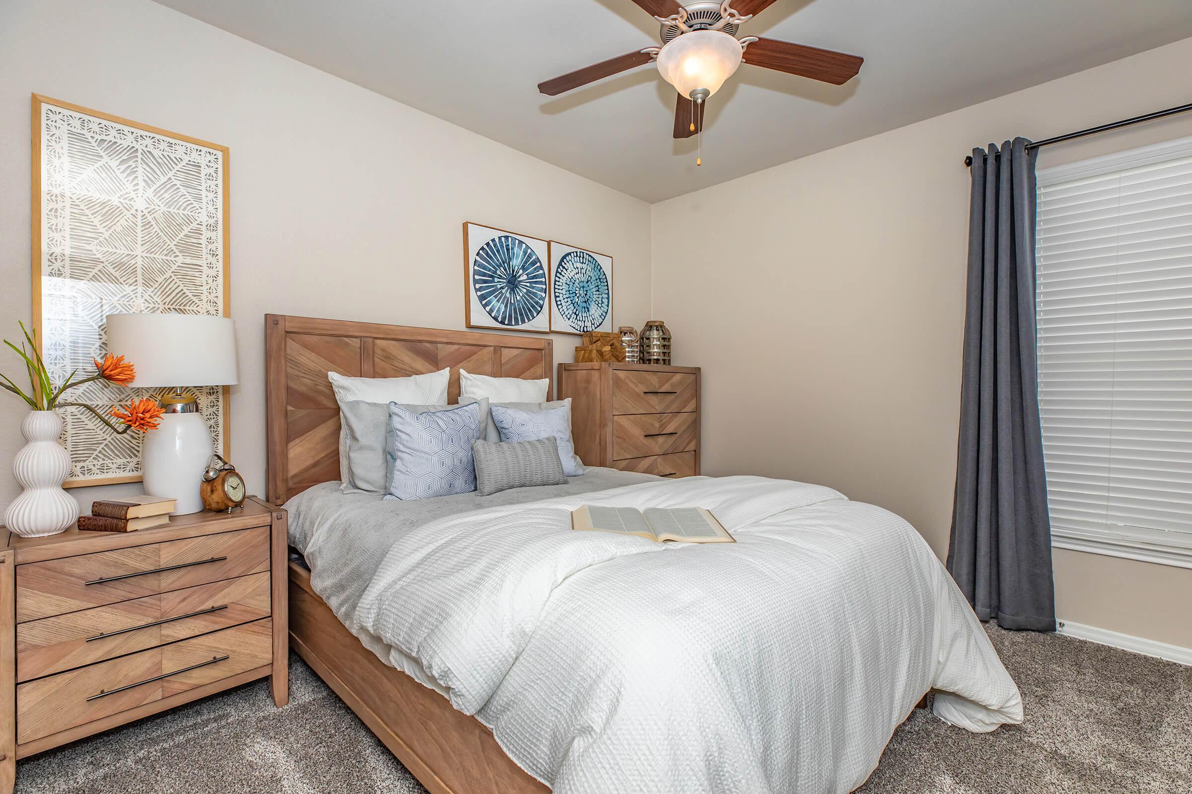 a bedroom with a white comforter