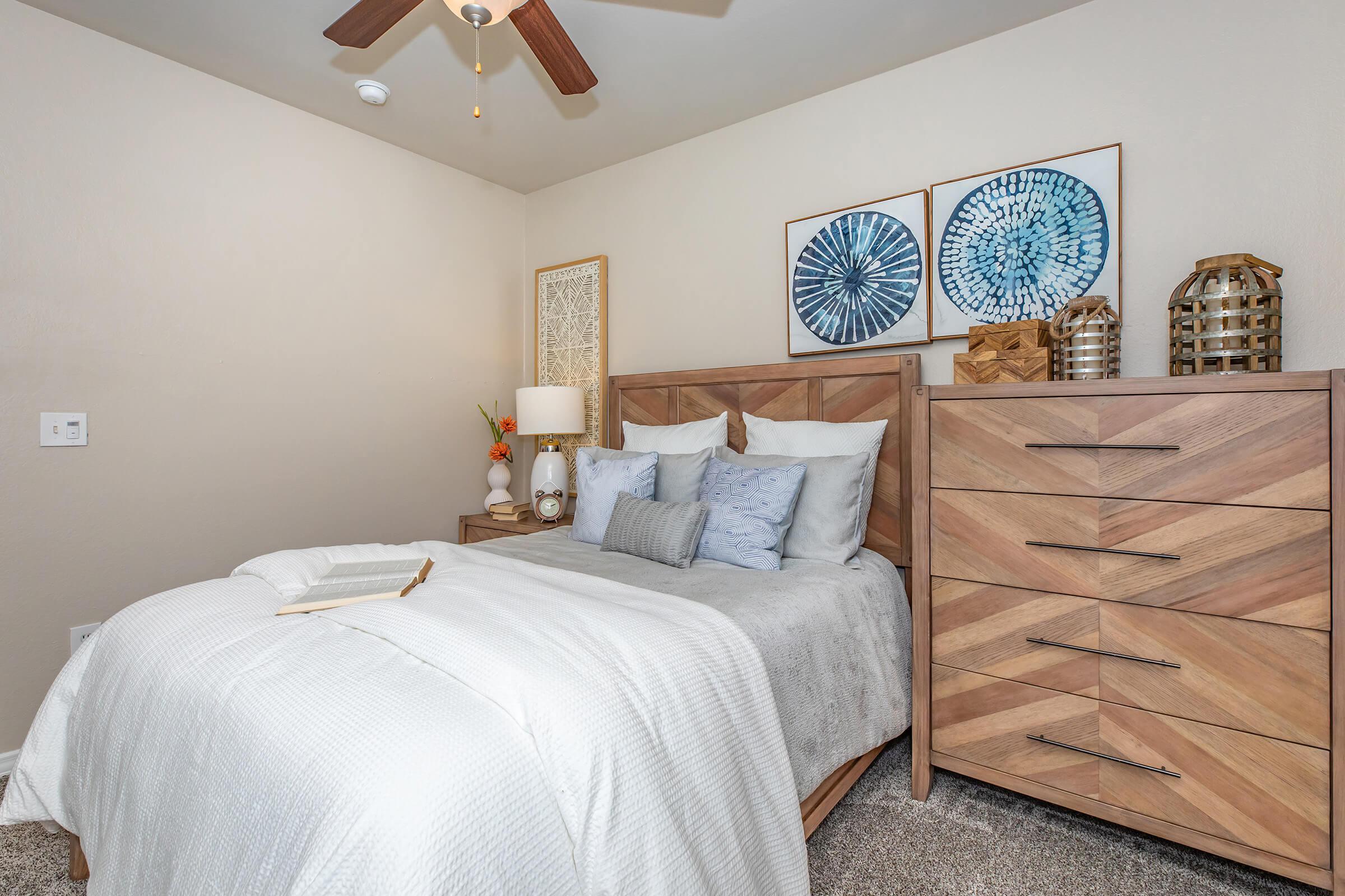 a bedroom with a wooden dresser