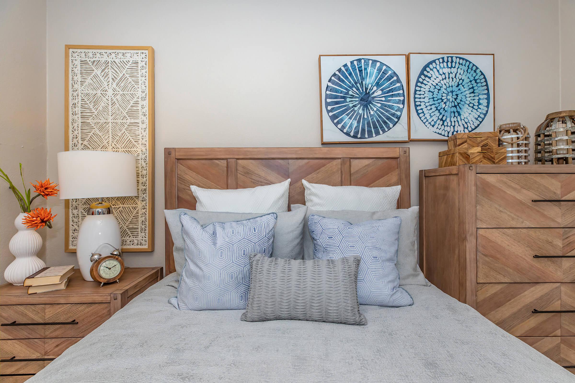 a bedroom with blue pillows