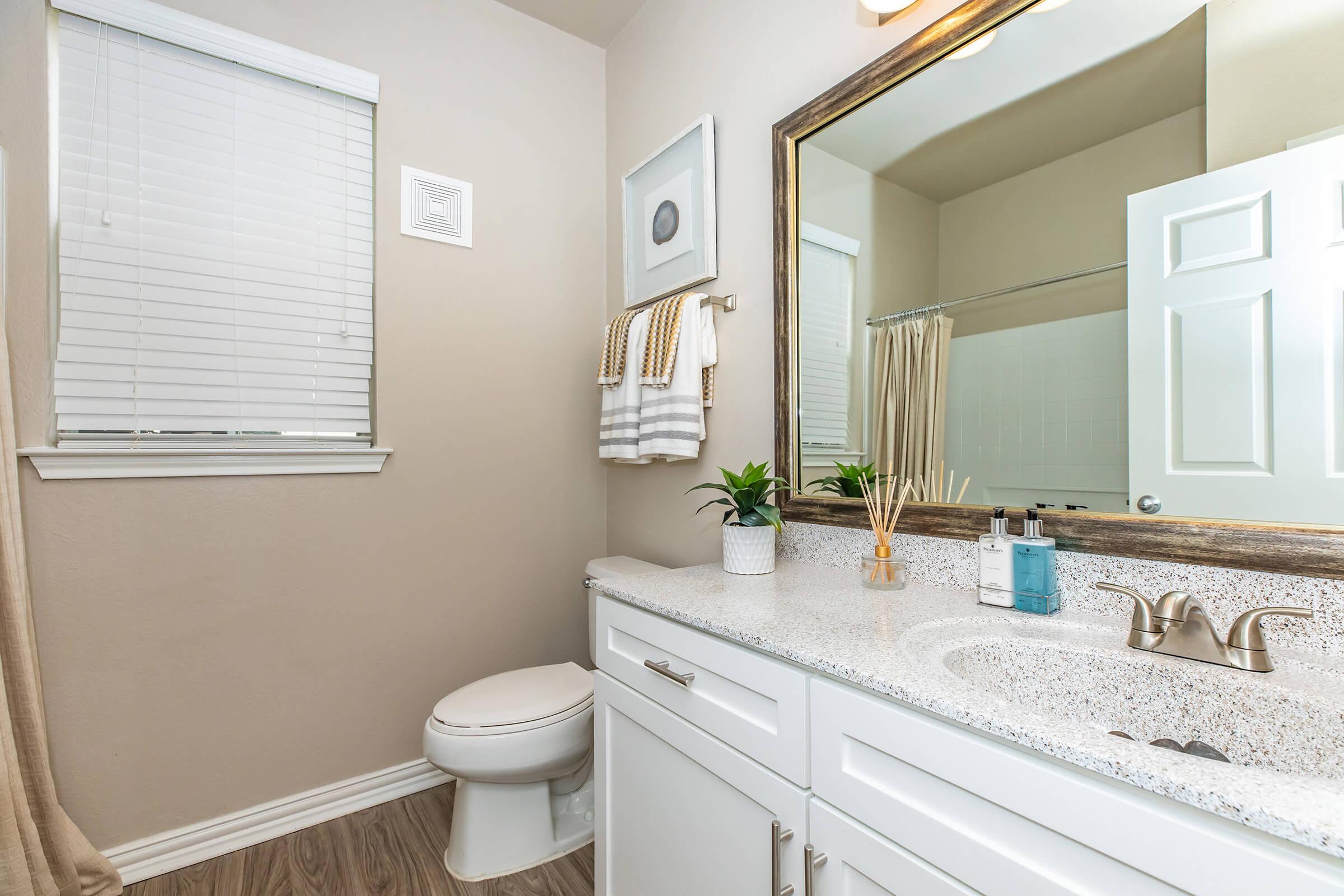 a bathroom with white cabinets