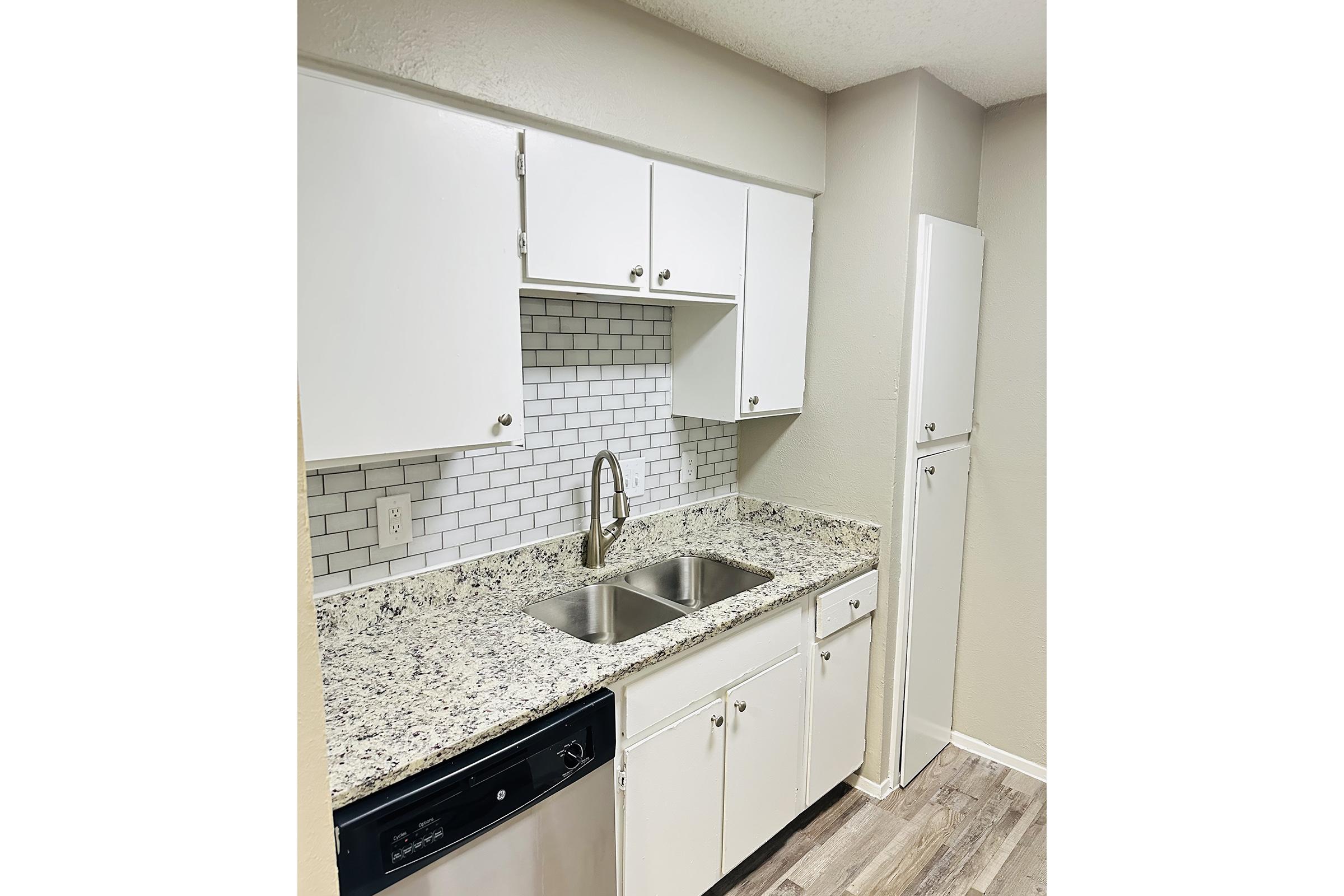 a kitchen with a sink and a mirror