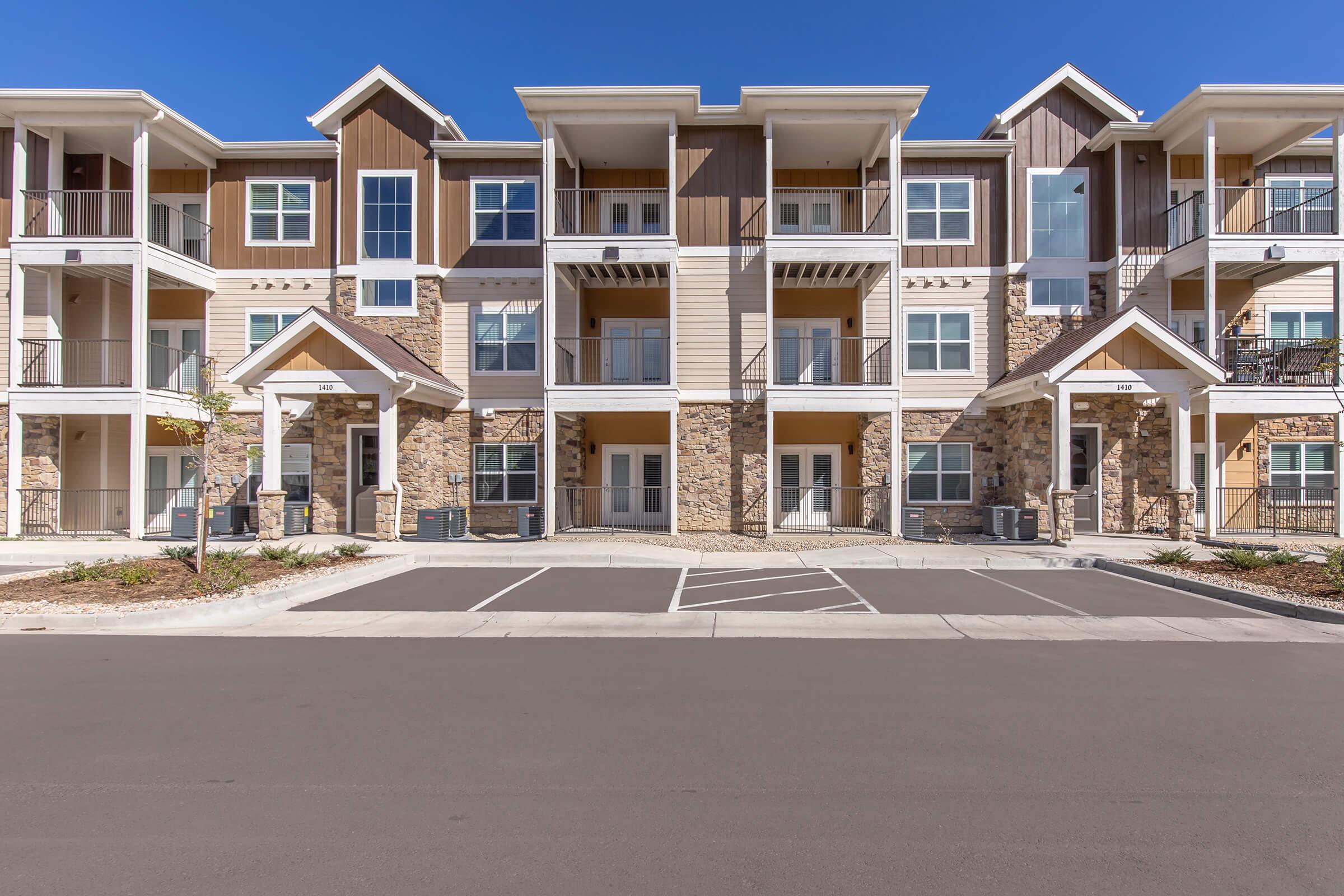 an empty parking lot in front of a house