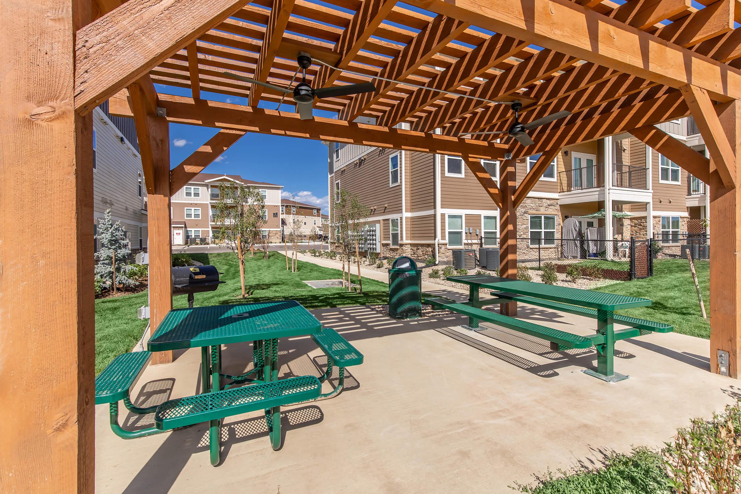 a couple of lawn chairs sitting on top of a wooden bench