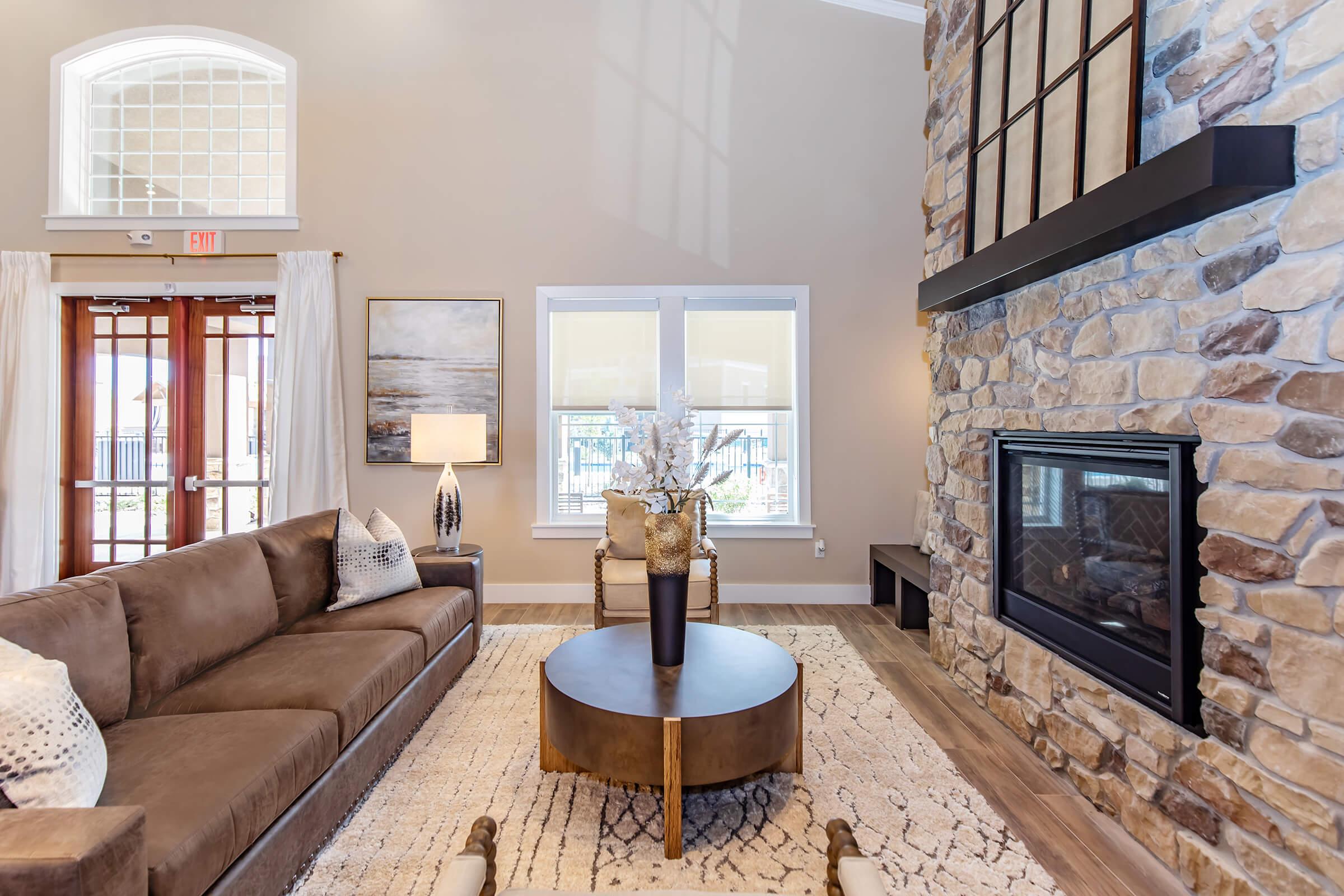 a fire place sitting in a living room filled with furniture and a fireplace