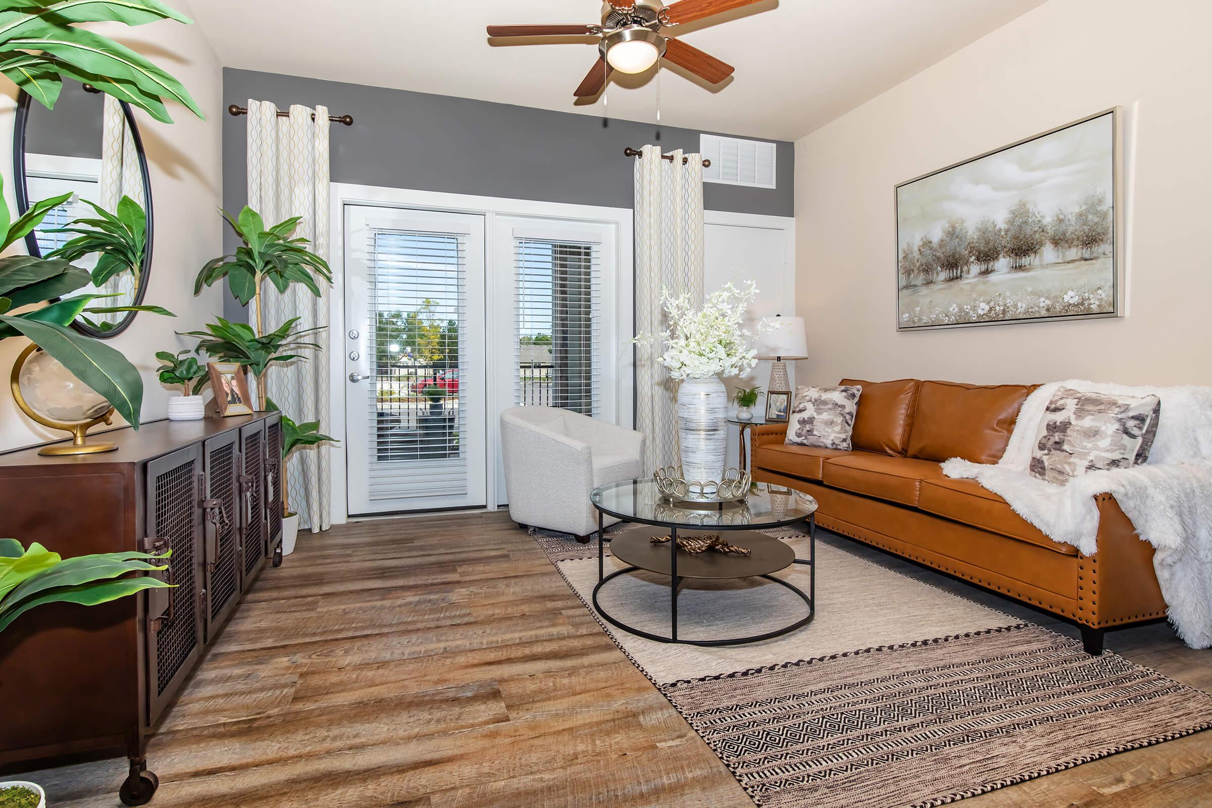 a living room filled with furniture and a large window