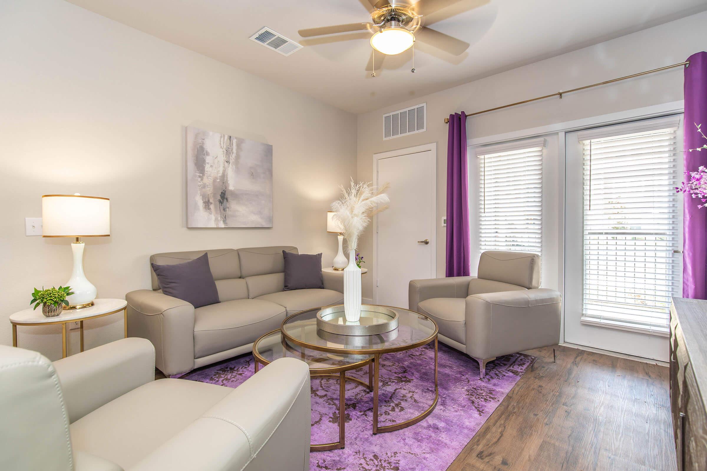 a living room filled with furniture and a large window