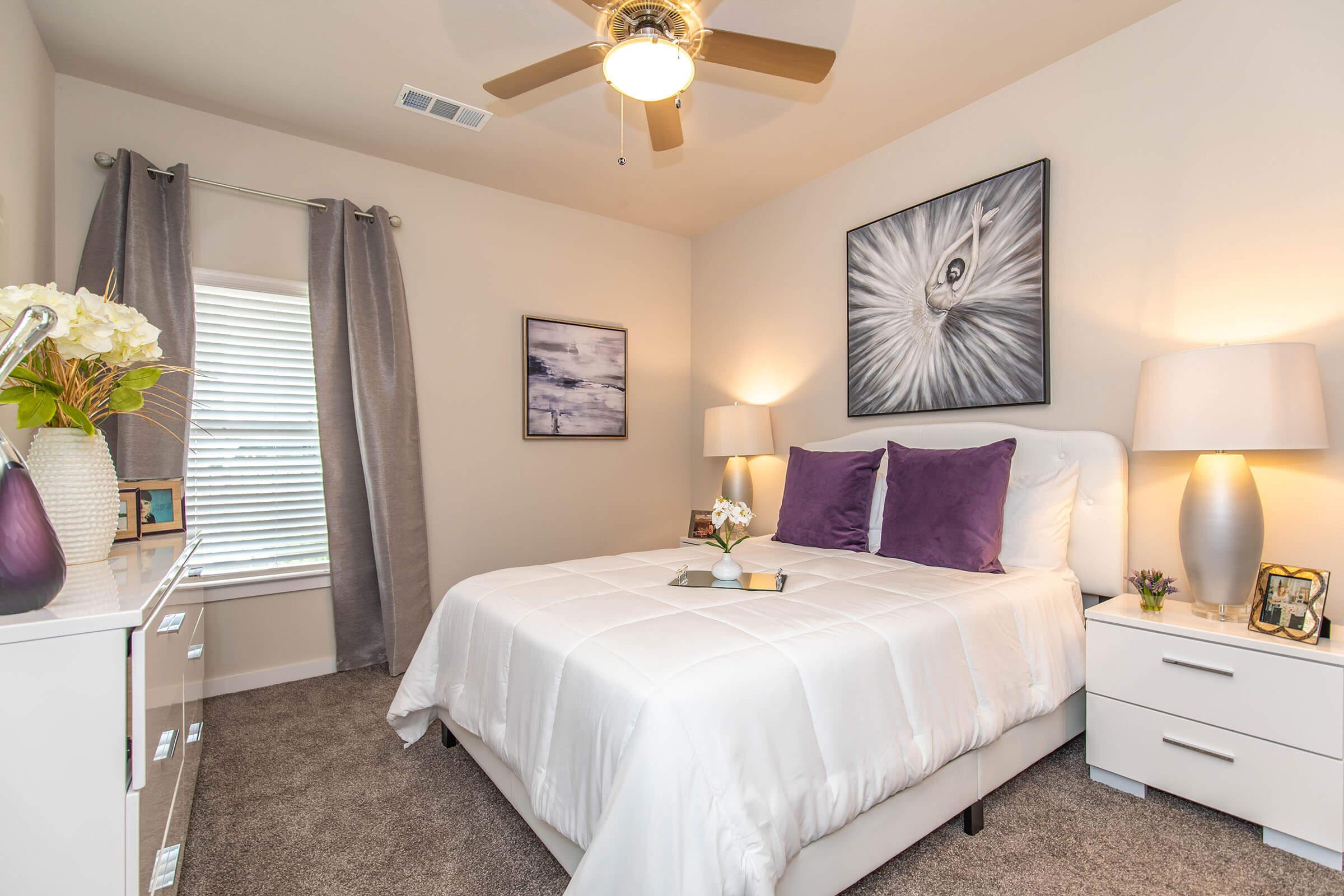 a bedroom with a bed and desk in a room