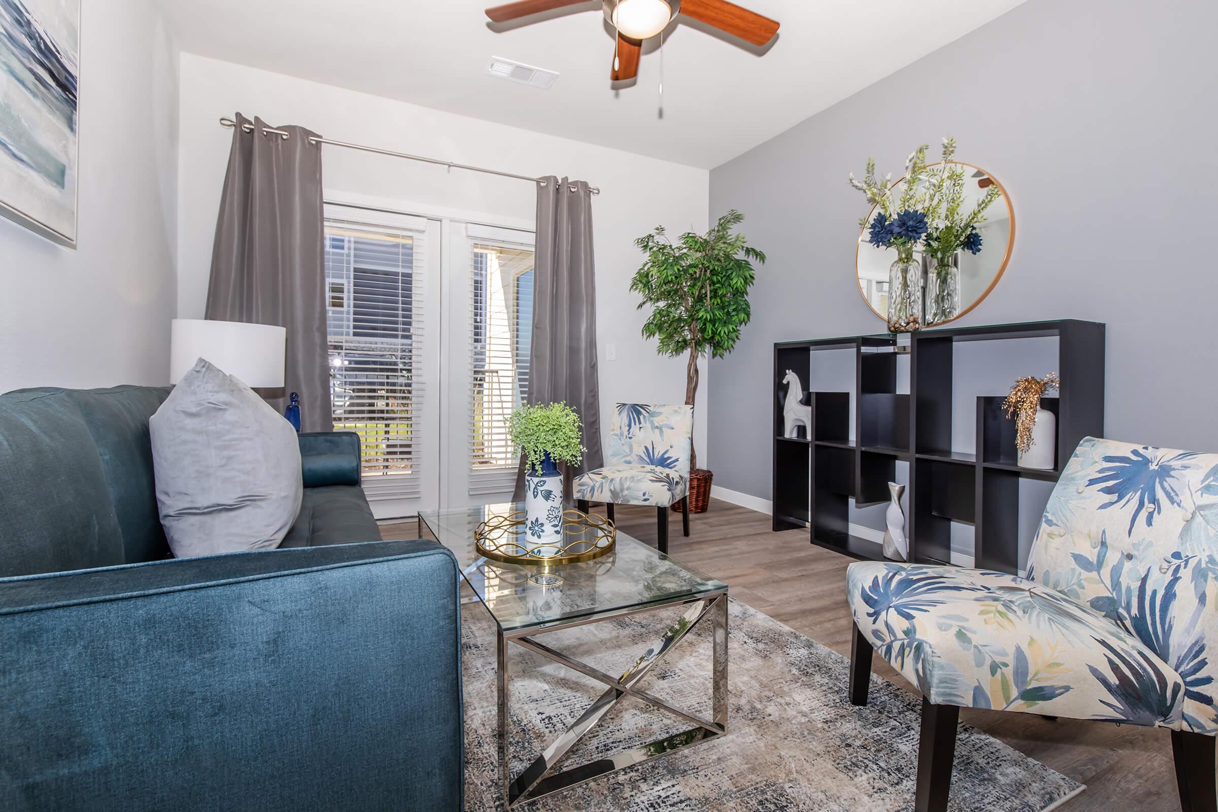 a living room filled with furniture and a large window