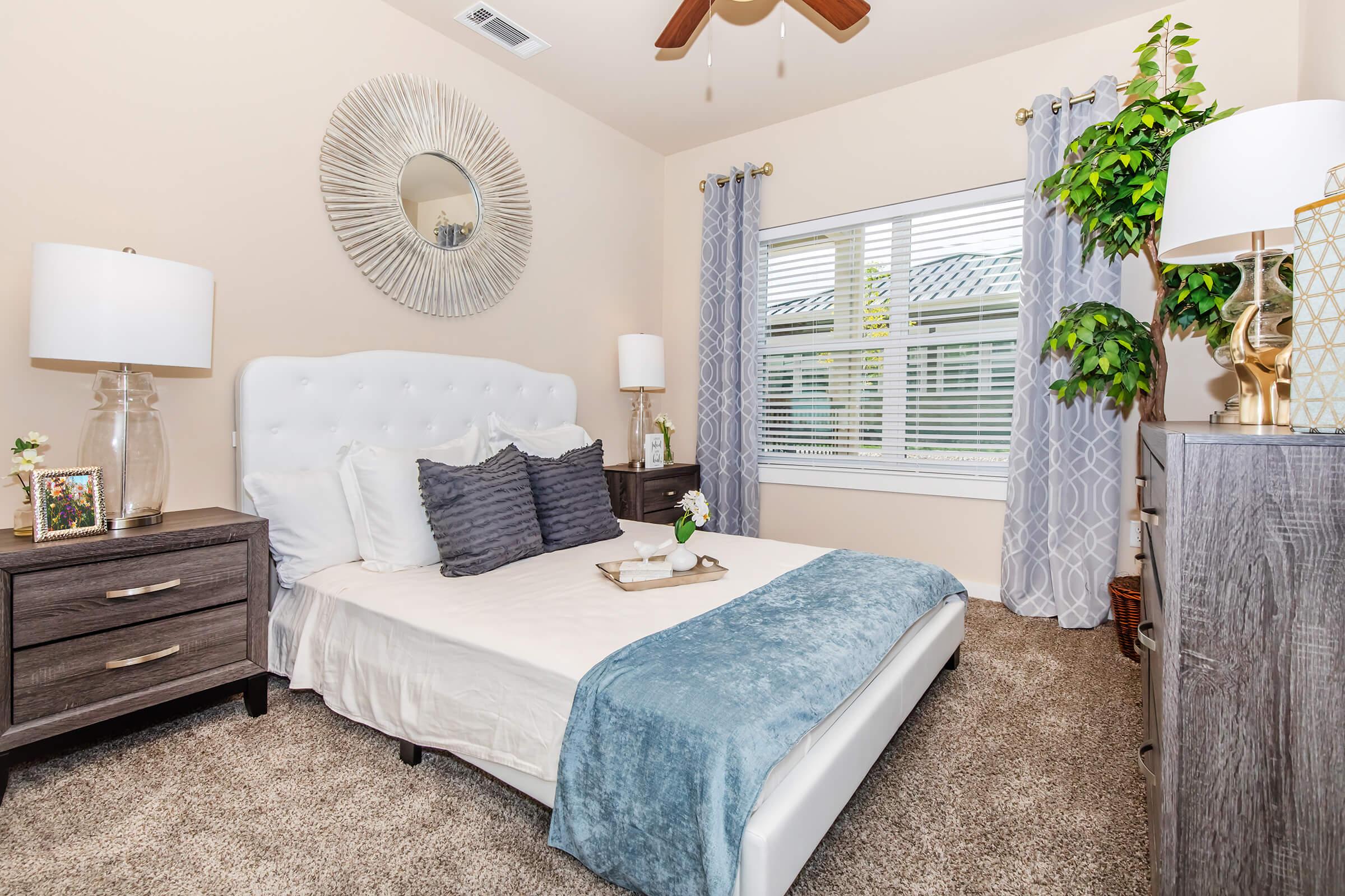 a bedroom with a bed and desk in a room