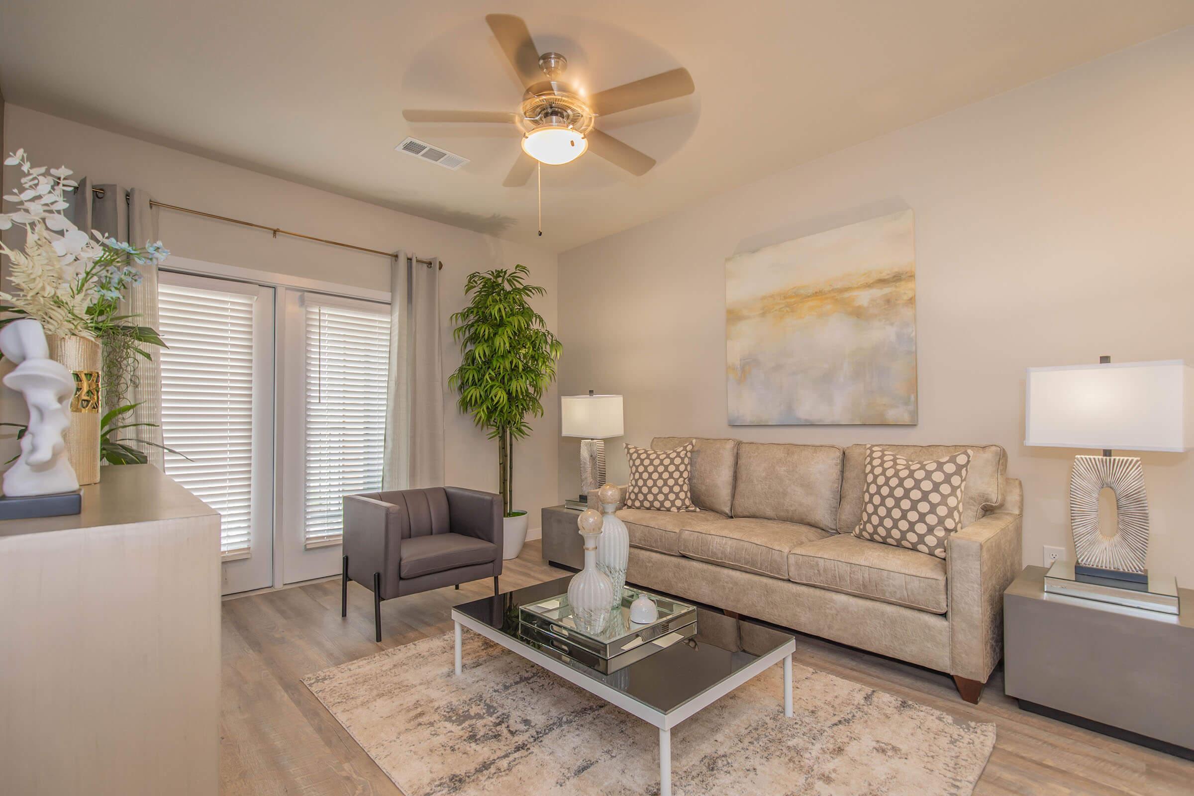 a living room filled with furniture and a large window