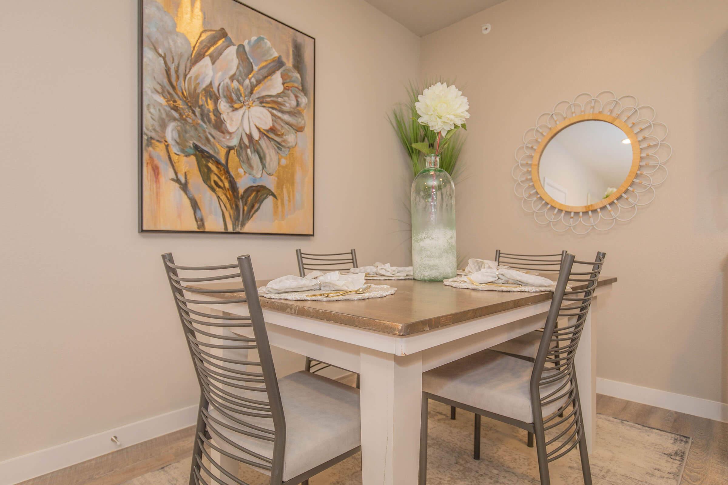 a room filled with furniture and vase of flowers on a table