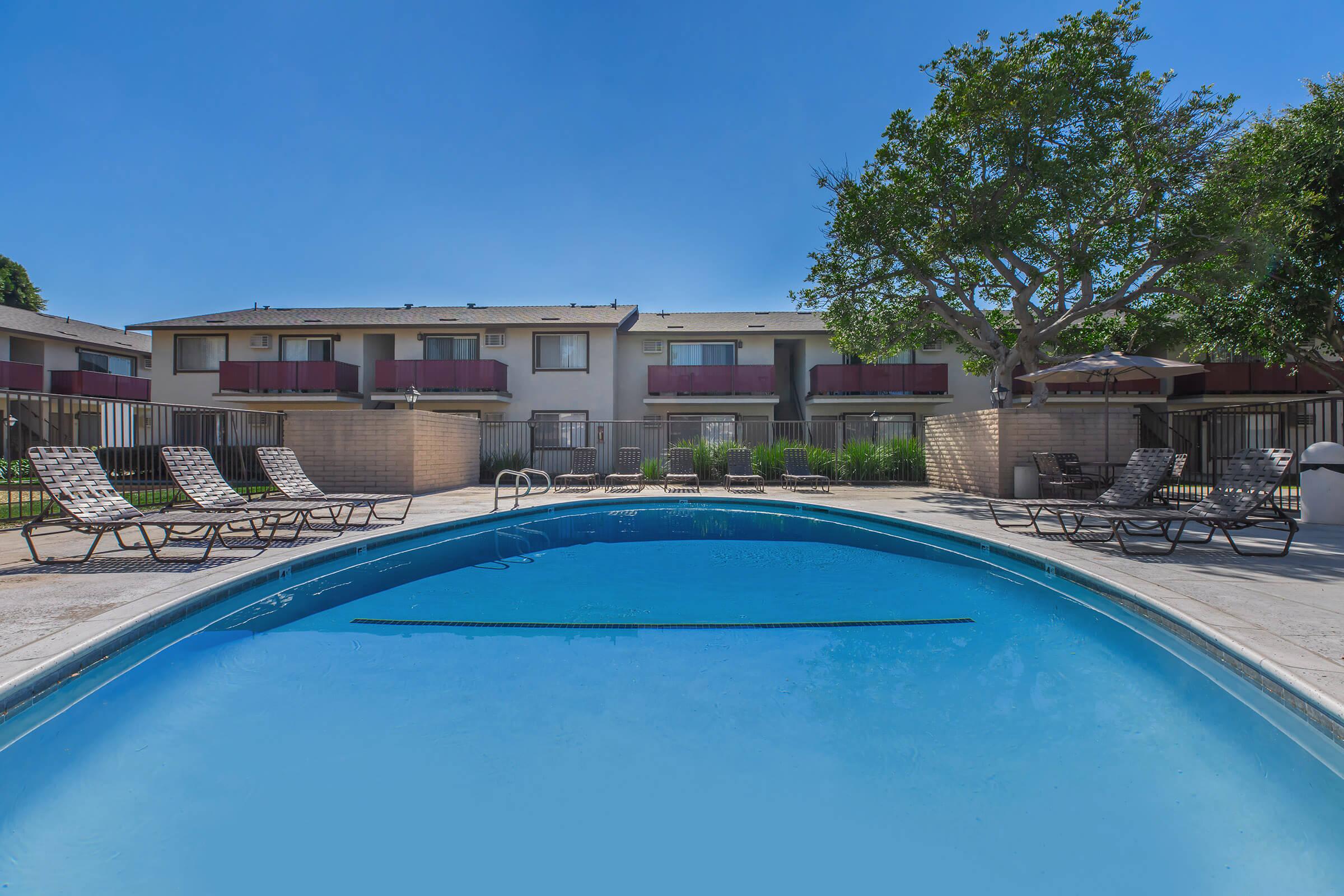 Del Amo Apartment Homes community pool surrounded with chairs
