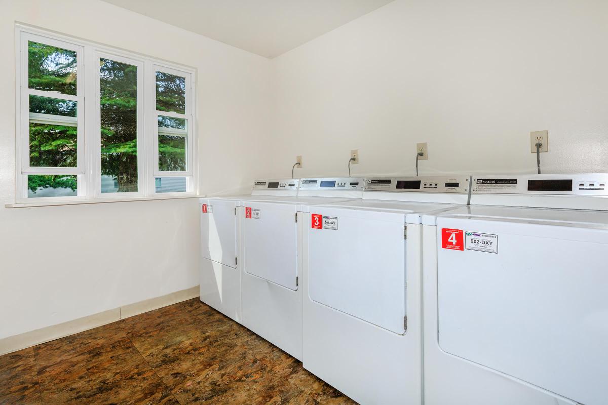 a kitchen with a white tub sitting next to a window