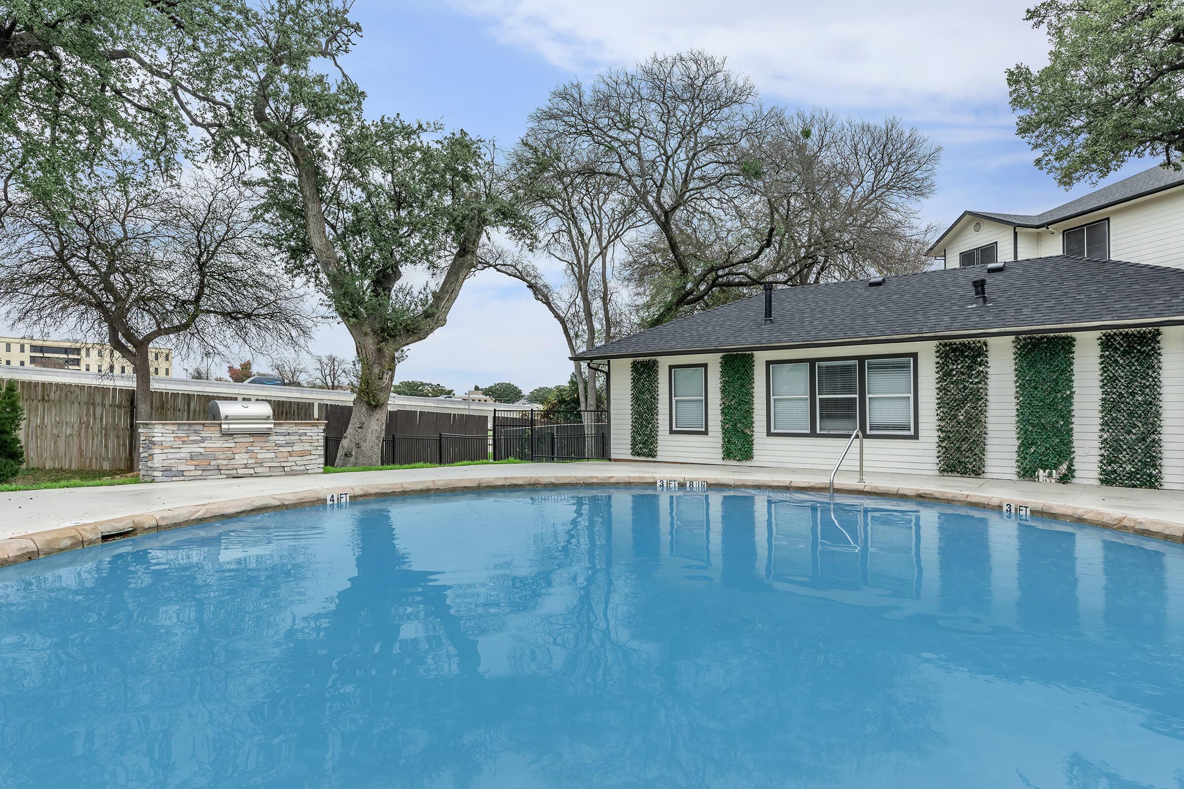 a large pool of water in front of a house