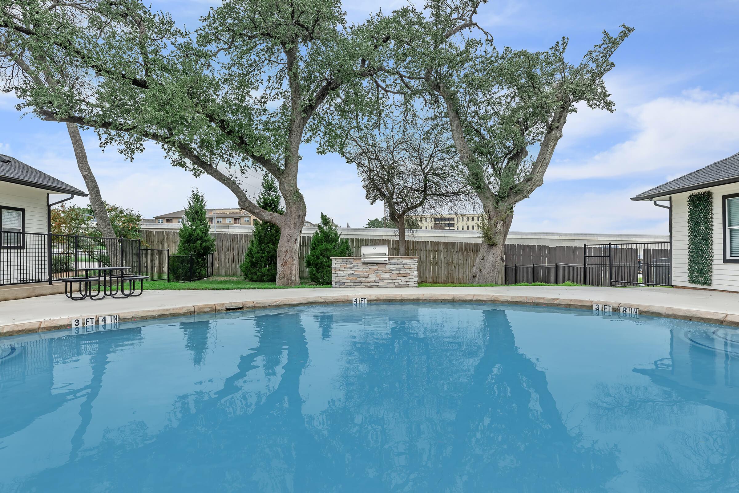 a large pool of water in front of a house