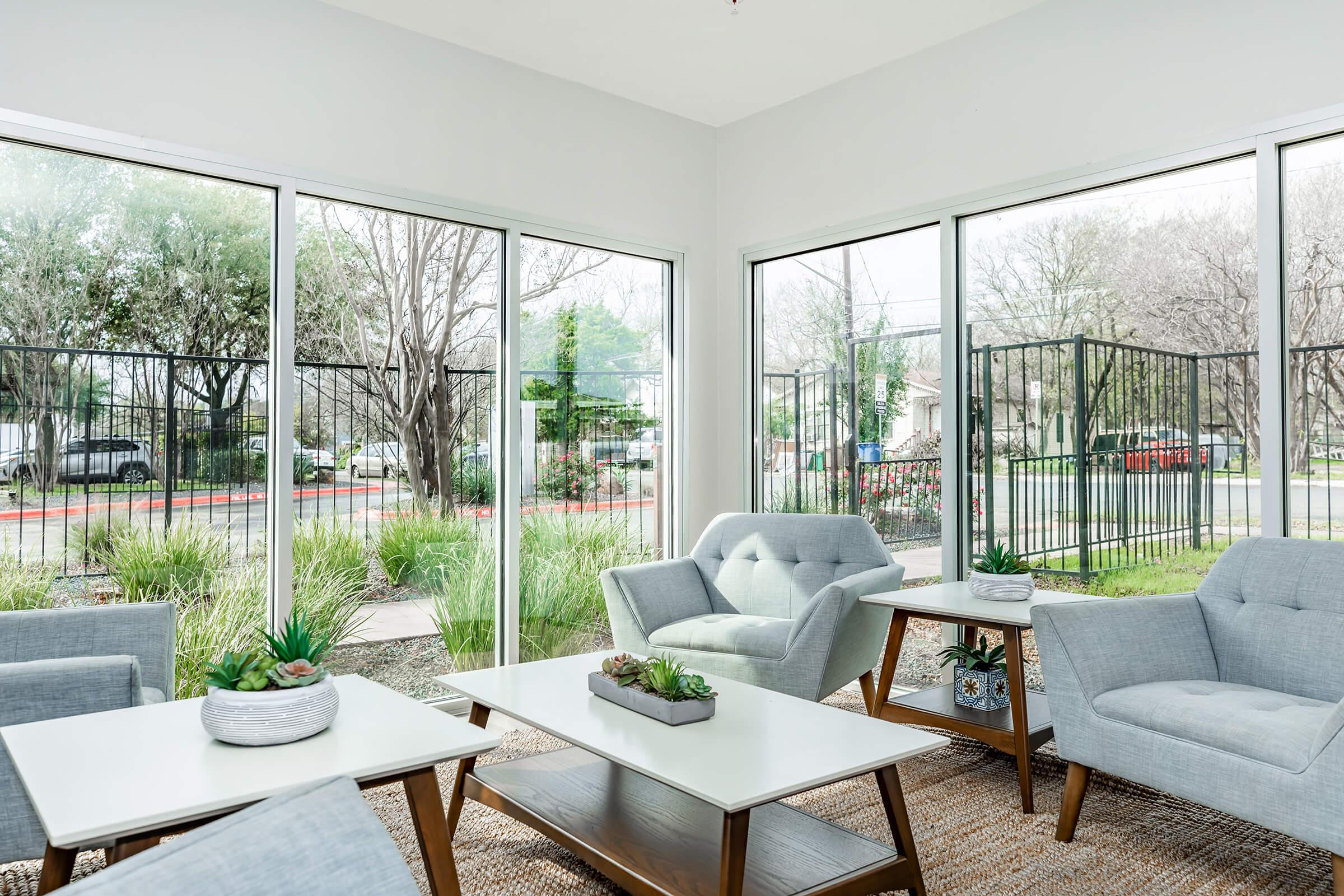 a living room filled with furniture and a large window