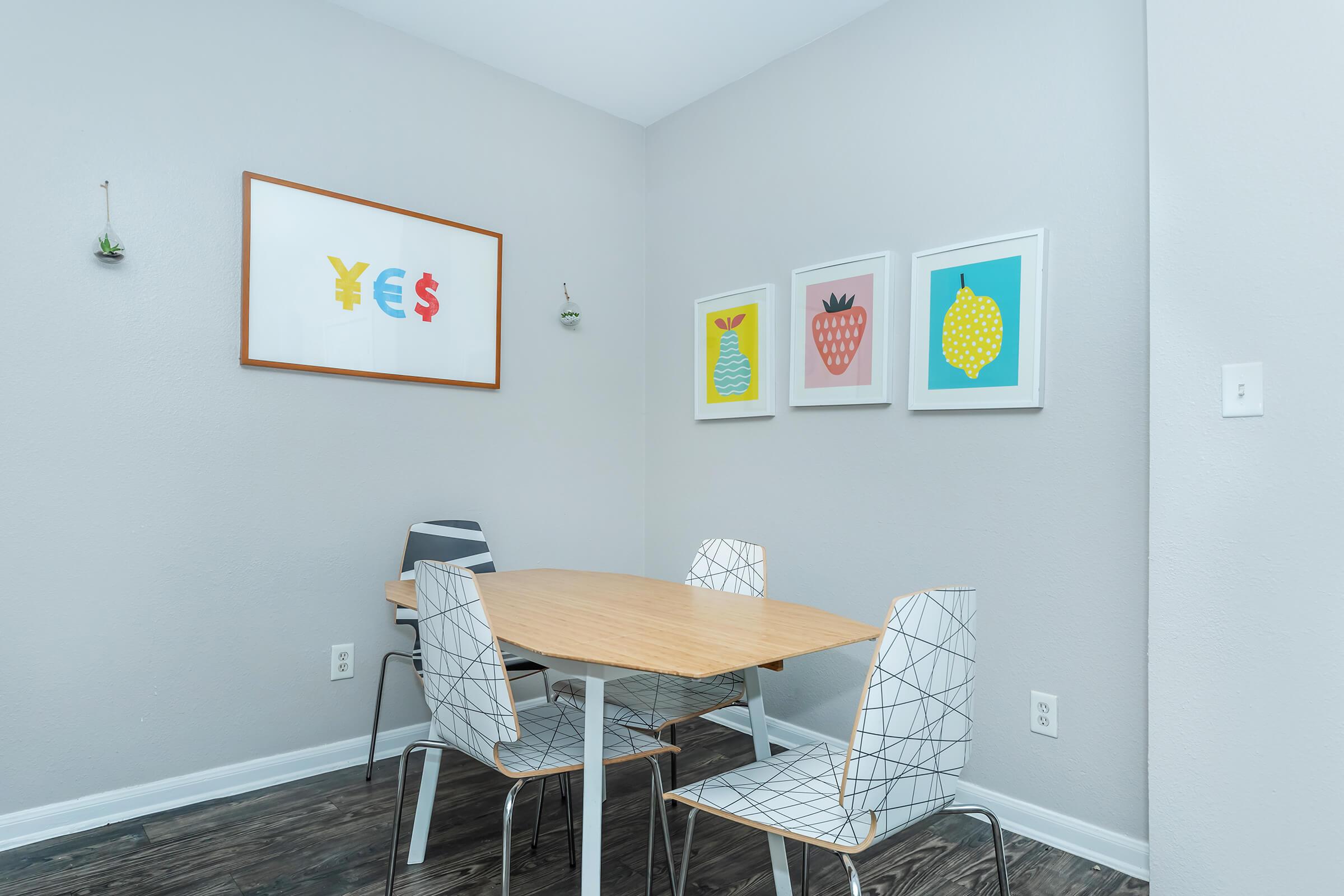 a bedroom with a desk and chair in a room