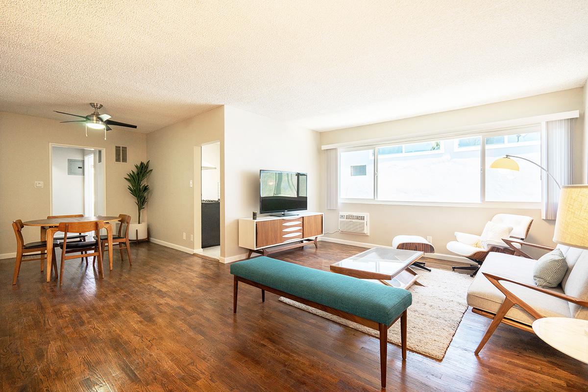 a living room filled with furniture and a large window