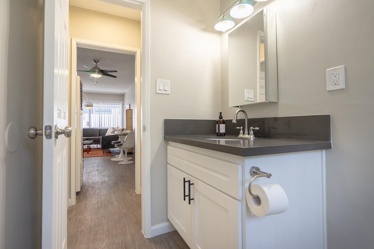 a kitchen with a sink and a mirror