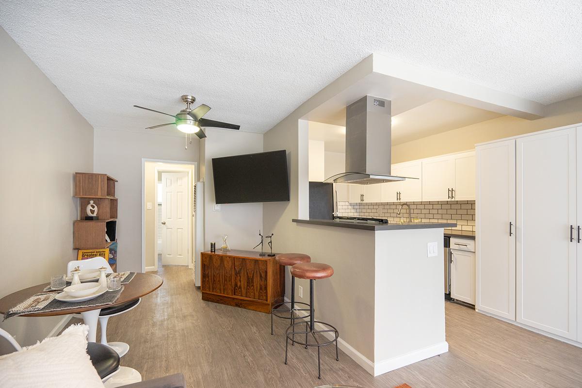 a living room filled with furniture and a refrigerator