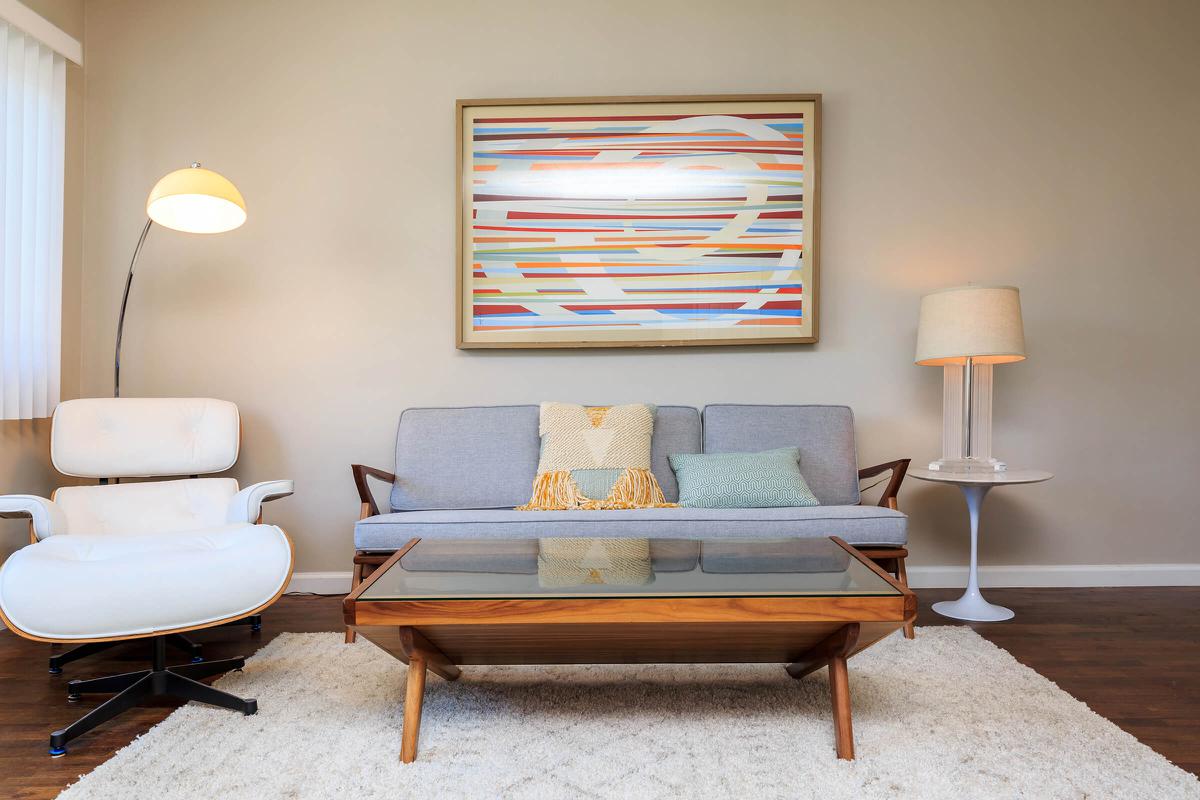a living room filled with furniture and a lamp