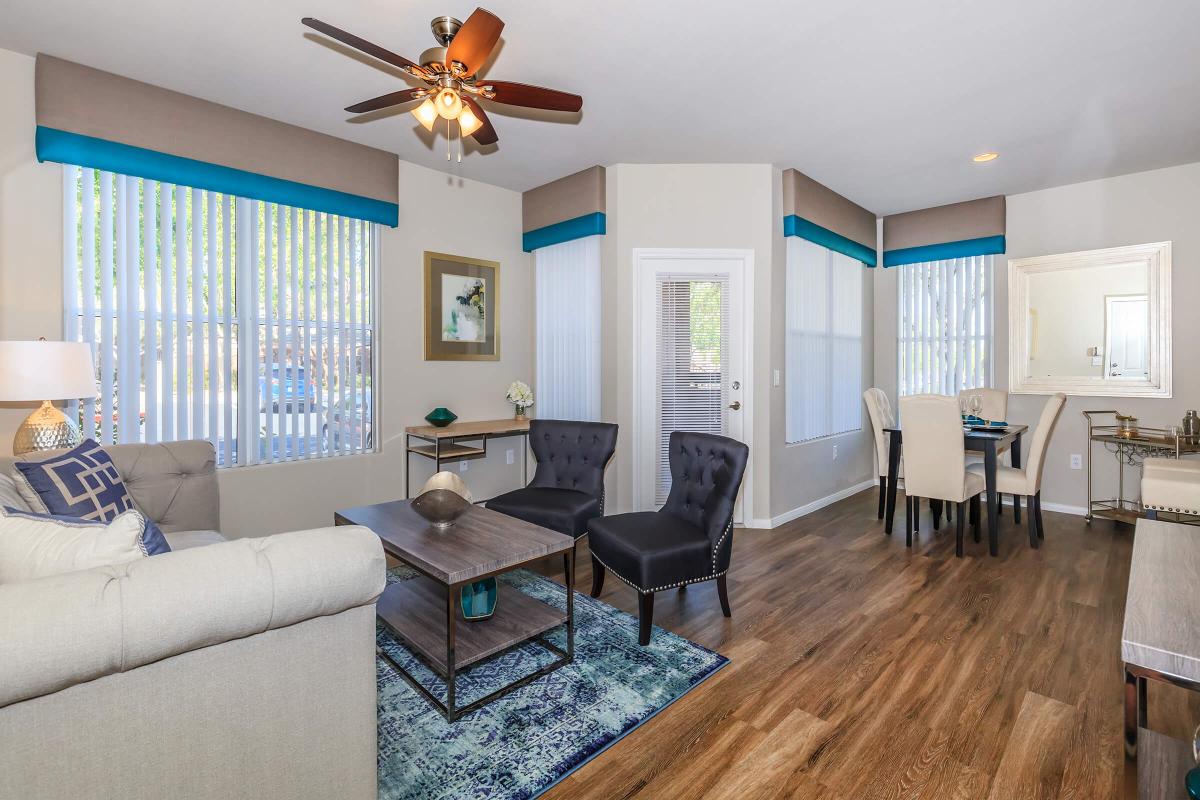 a living room filled with furniture and a large window