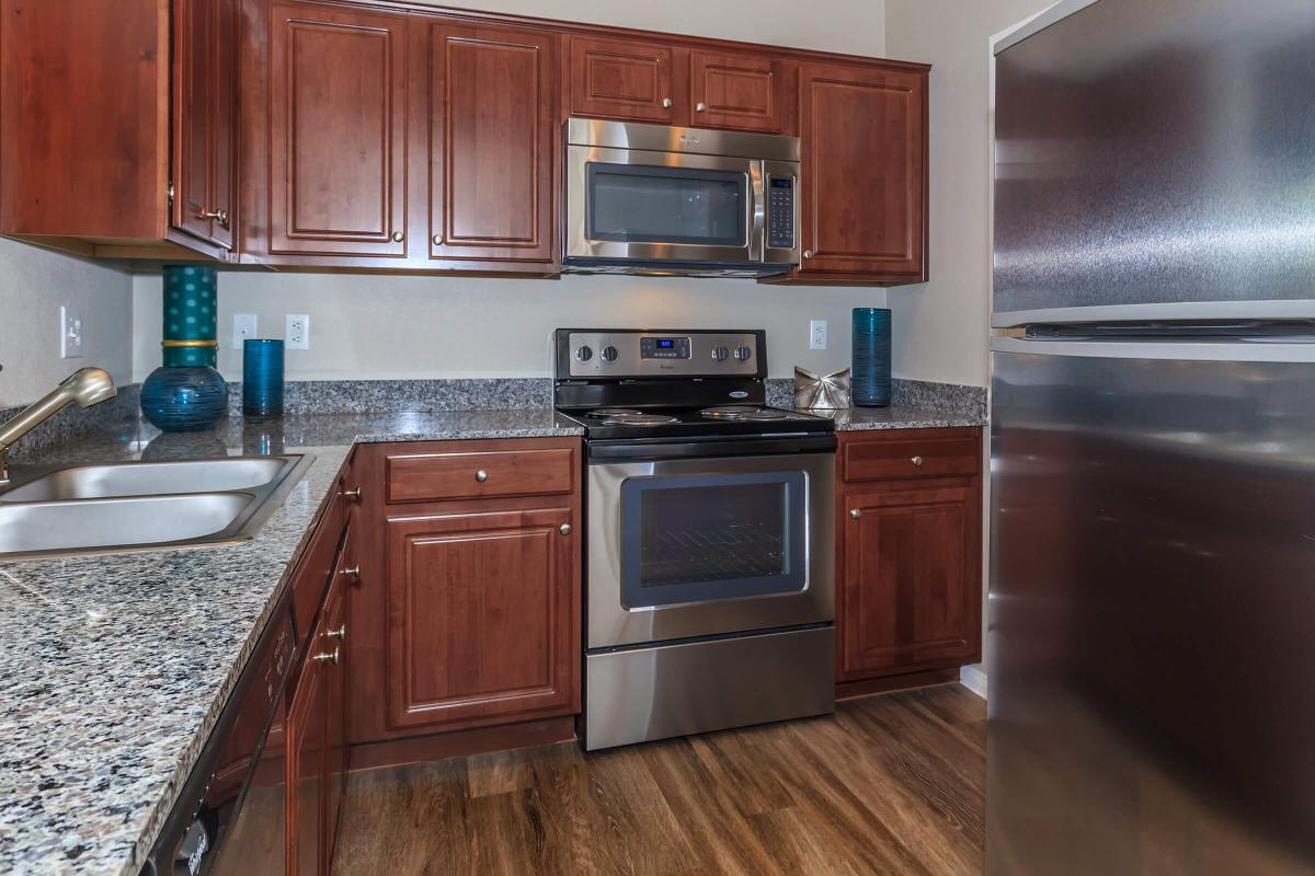 a kitchen with stainless steel appliances and wooden cabinets