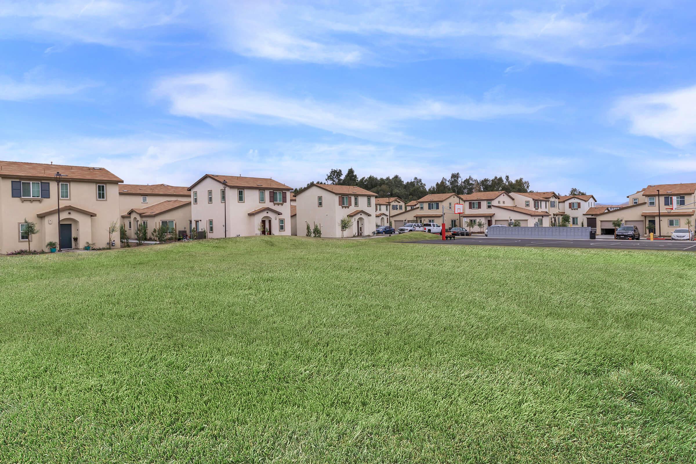 Green field in front of community buildings