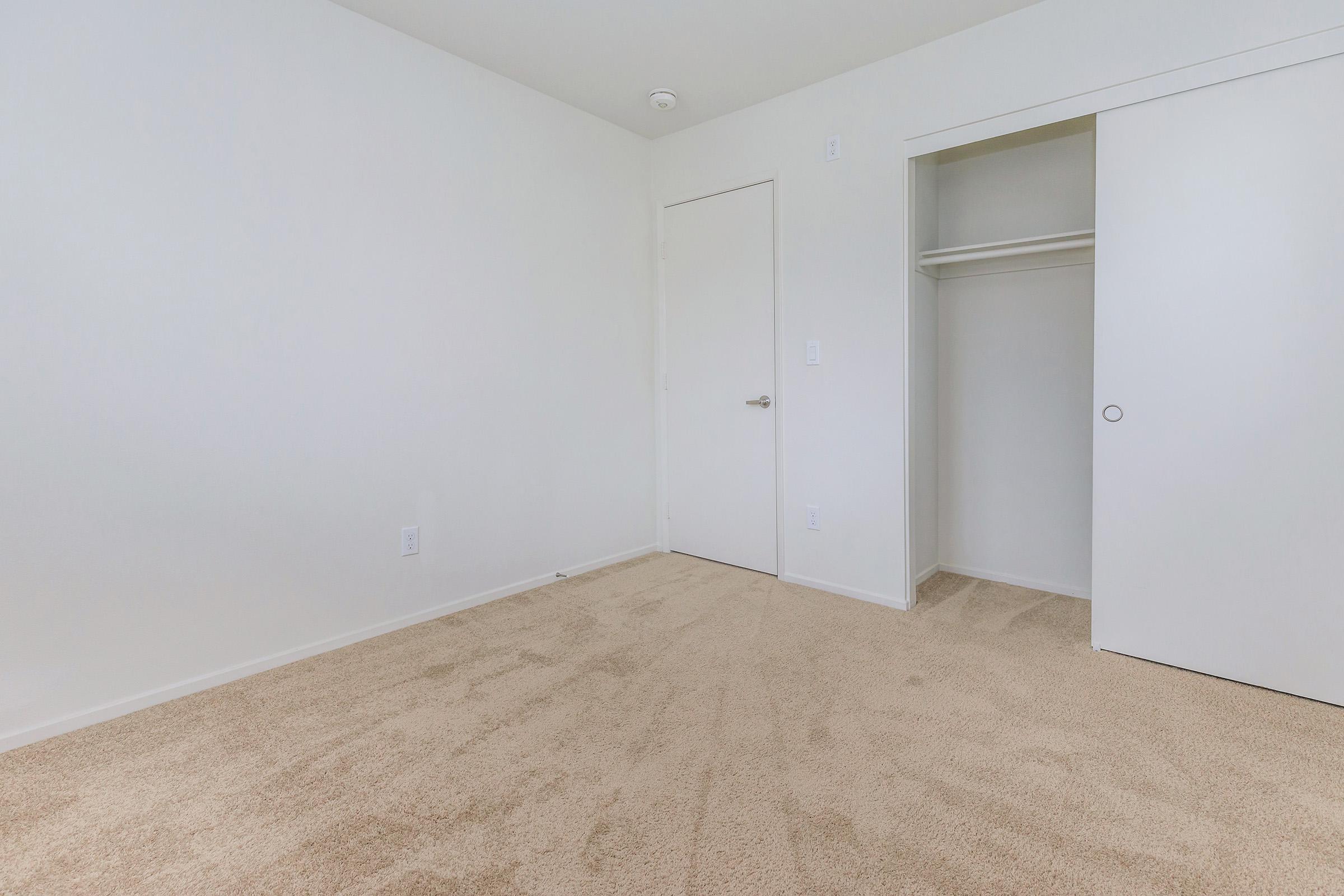 Bedroom with open sliding closet door