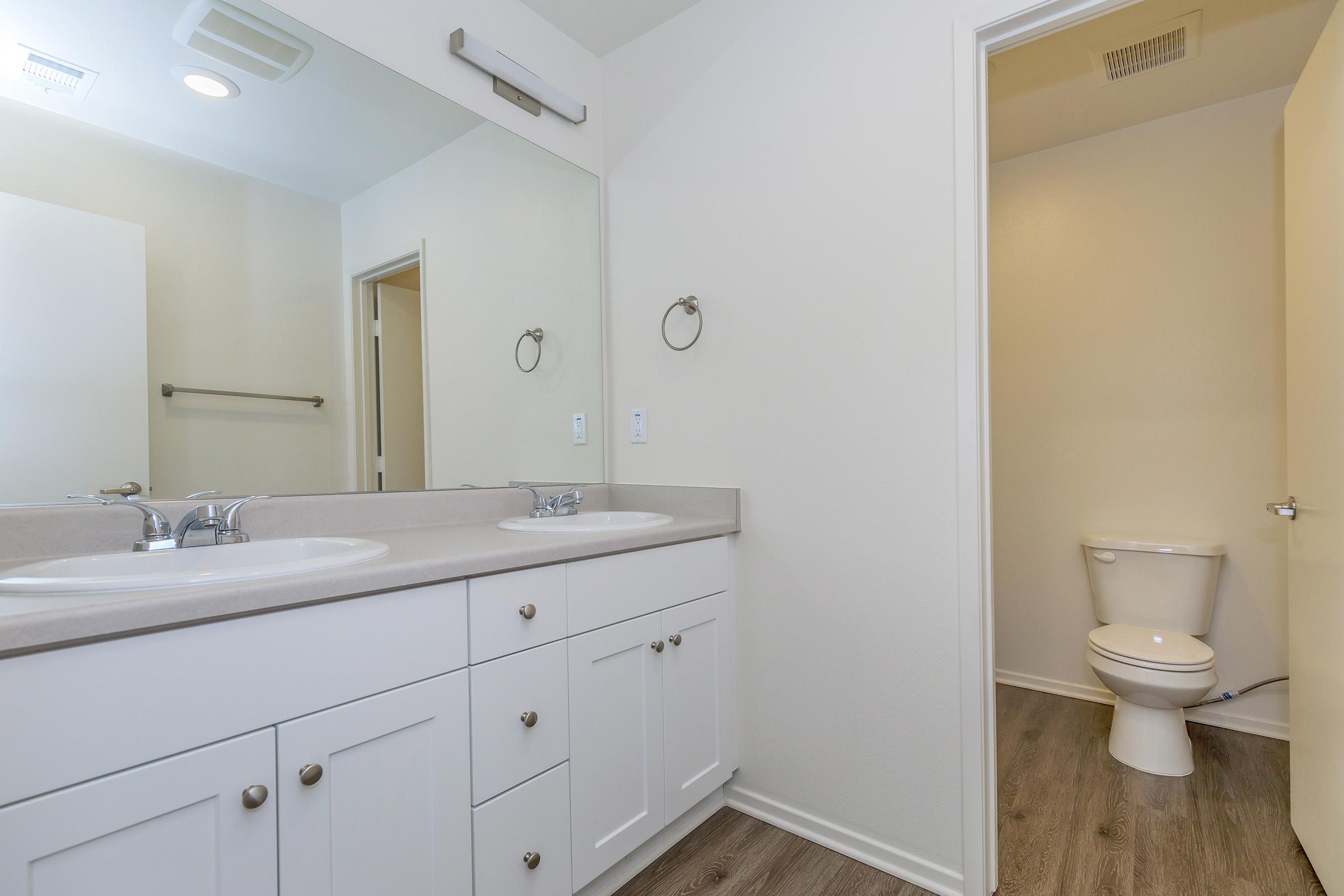 Vacant bathroom with wooden floors