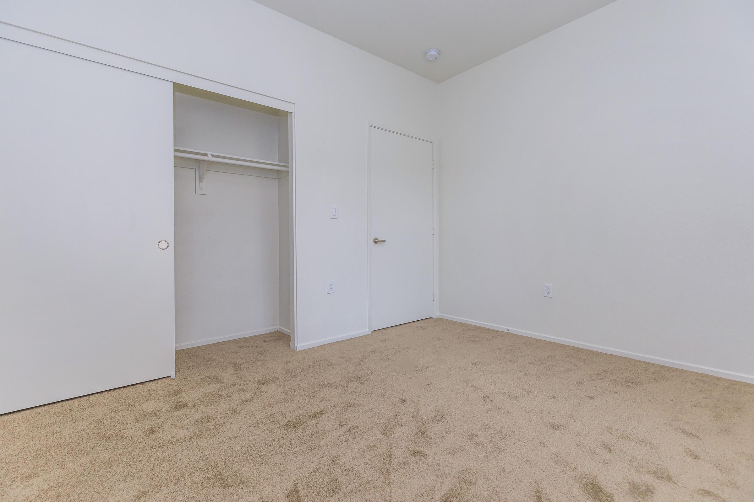 Vacant bedroom with open closet sliding door