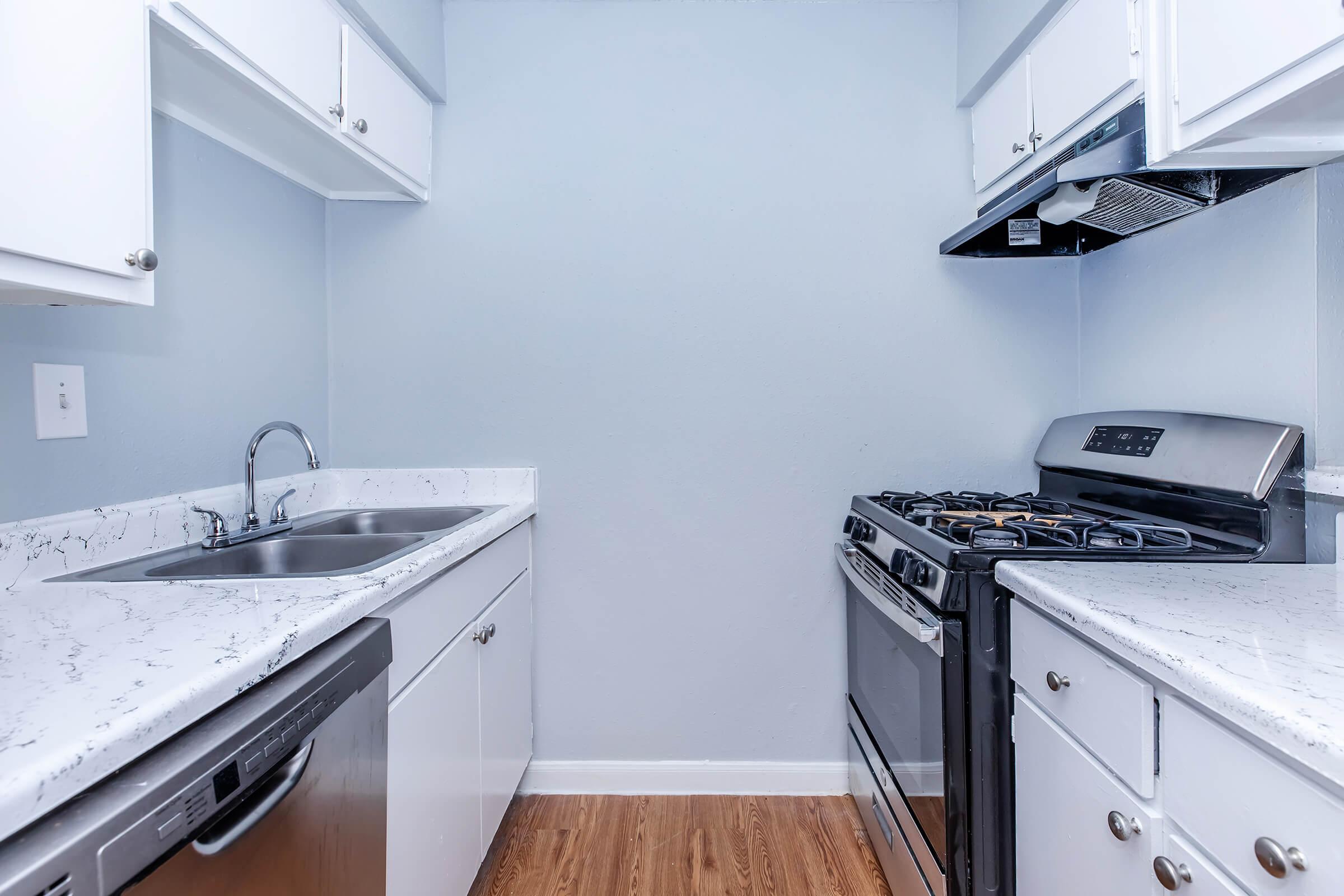 a kitchen with a stove and a sink