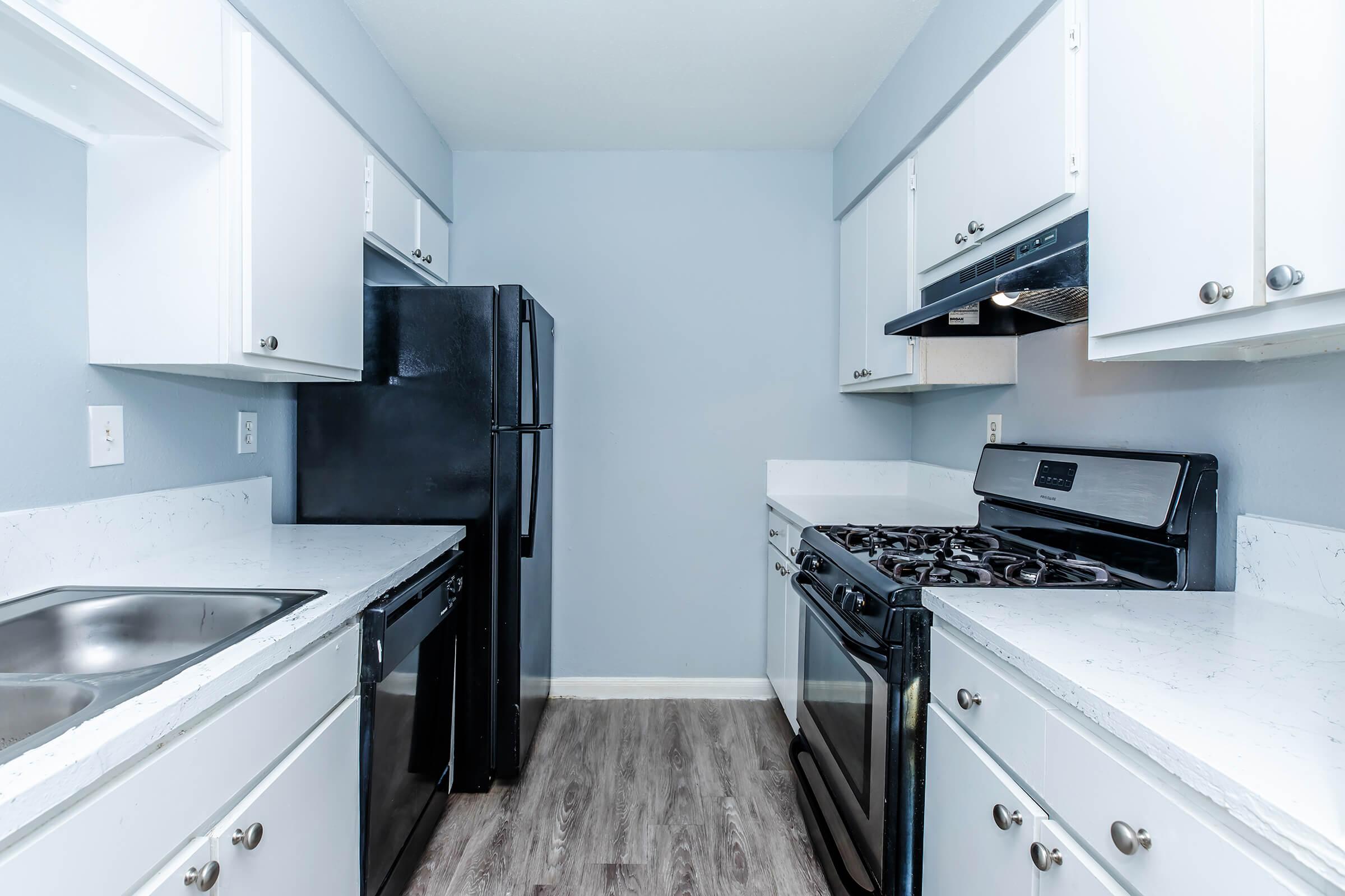 a kitchen with a stove and a sink