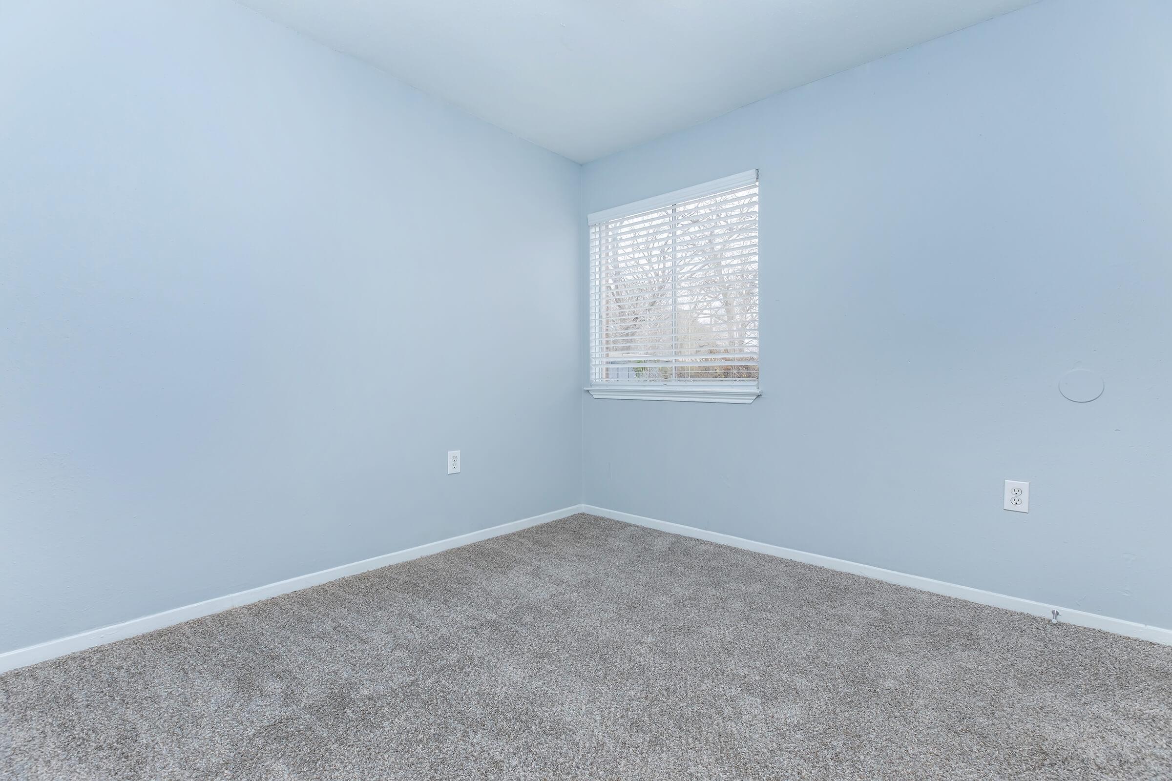 a bedroom with a large window